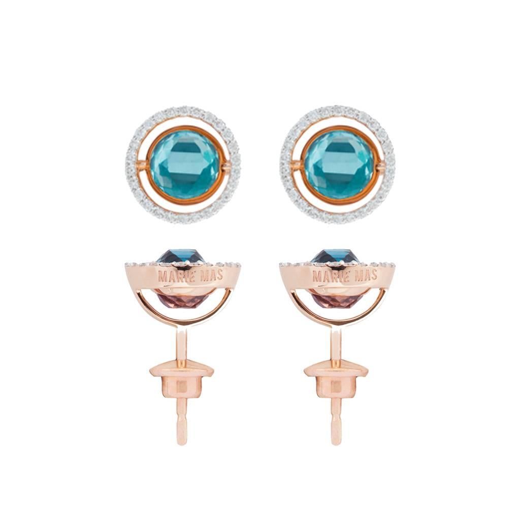 This pair of Swiveling Stud Earrings are from the French Jewelry brand Marie Mas. They are made in 18 Karat Rose Gold and the outer ring is paved with Diamonds.
On each earring, there is a Pink Amethyst and a London Blue Topaz back to back. You can