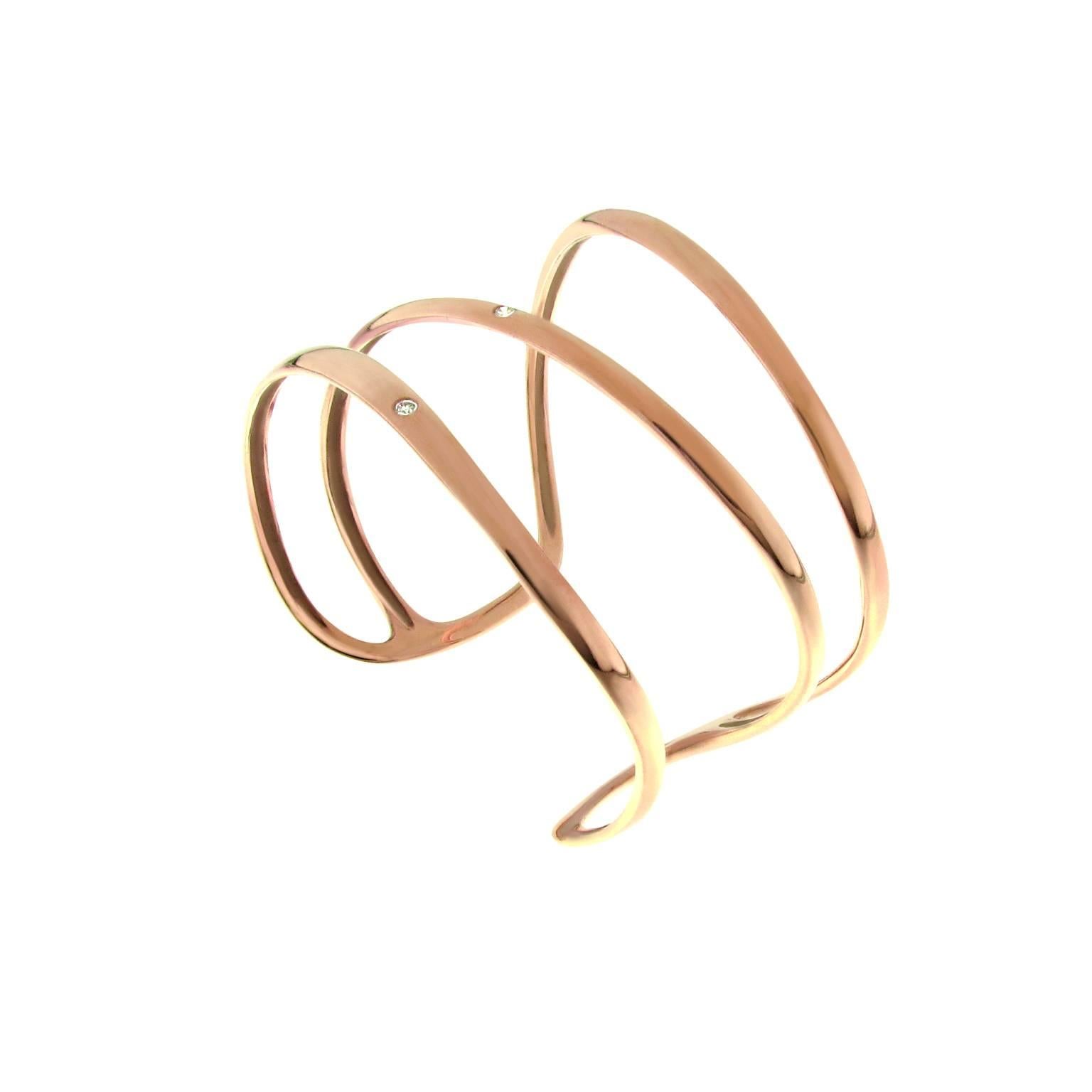 Timeless contemporary sculptured wide cuff bracelet in 18k rose gold. The bracelet features an open design and 3 sparkling round brilliant cut diamonds of total 0.15ct. 
Signed and hallmarked Gavello. 
The brand is known for its impeccable