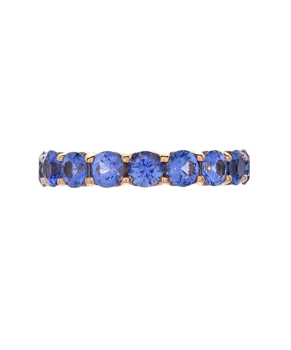This simple eternity band crafted in 18 karat yellow gold features over 6.4 carats of matching 4 mm ceylon blue sapphires. 

Designed and made in Los Angeles - 2016. 

All items can be ordered in a specific size or budget. 

Please contact us with
