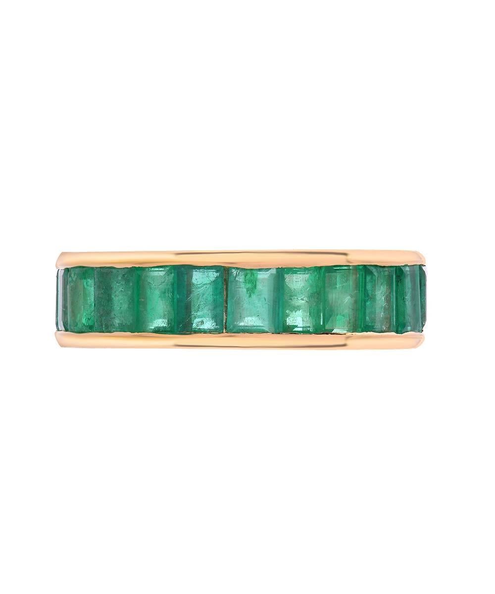 This simple eternity band crafted in 18 karat yellow gold features over 3 carats of matching 5 mm baguette emeralds. The ring is a standard US size 6.

Designed and made in Los Angeles - 2016. 

All items can be ordered in a specific size or budget.