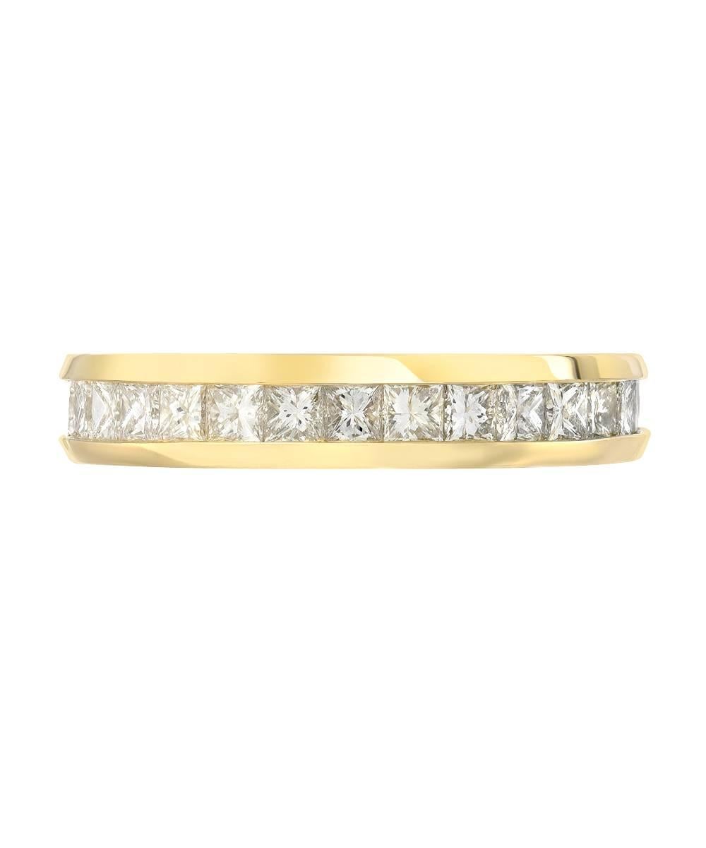 This simple eternity band crafted in 14 karat yellow gold features over 2.5 carats of matching 3 mm princess diamonds featuring. The ring is a standard US size 7 and features a unique tall and bulky mounting. 

Designed and made in Los Angeles.

All