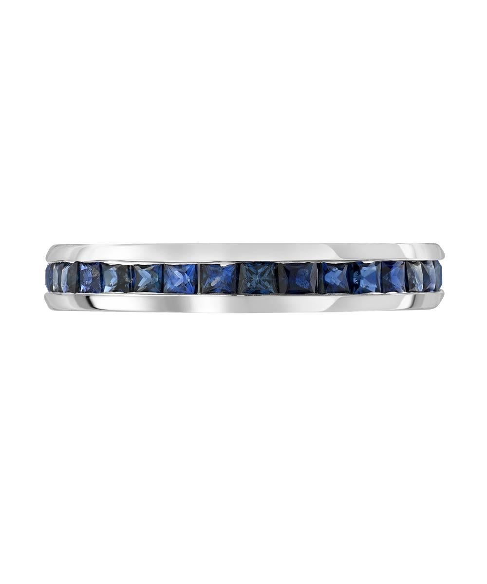 This simple eternity band crafted in 14 karat white gold features 3.5 carats of matching 2 mm princess cut royal blue sapphires. The ring is a standard US size 7 and is designed to be a tall and bulky mounting. 

Designed and made in Los