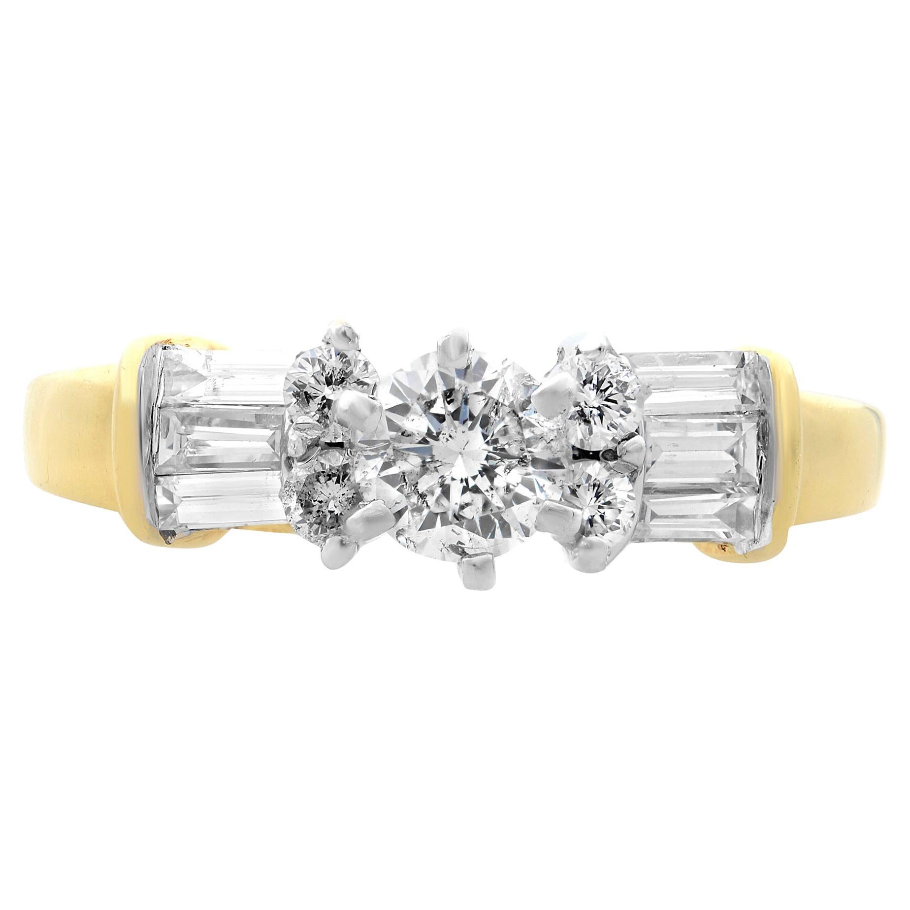 This beautiful ladies engagement ring is crafted in 14k yellow and white gold. It features a center prong set round brilliant cut diamond with baguette and round cut diamonds on each side. Total diamond weight: 1.00 carat. Diamond quality: H color
