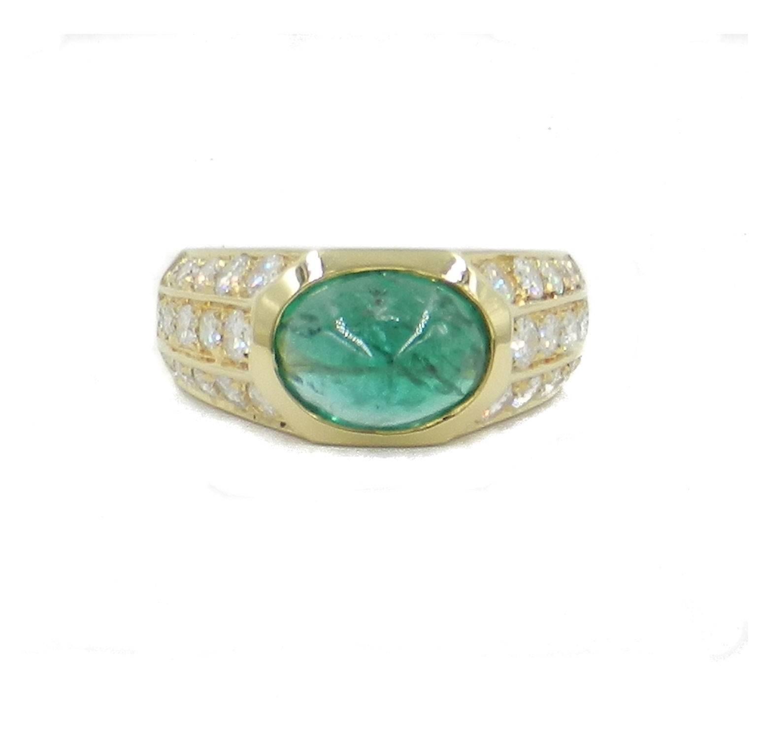 Ring in 18kt yellow gold ring with natural oval cabochon emerald weight carat 2.50 ring and white round diamonds total weight carat 1.10. Produced in Italy circa 1960. Perfect to wear on the pinky ring. Ring size 50.5