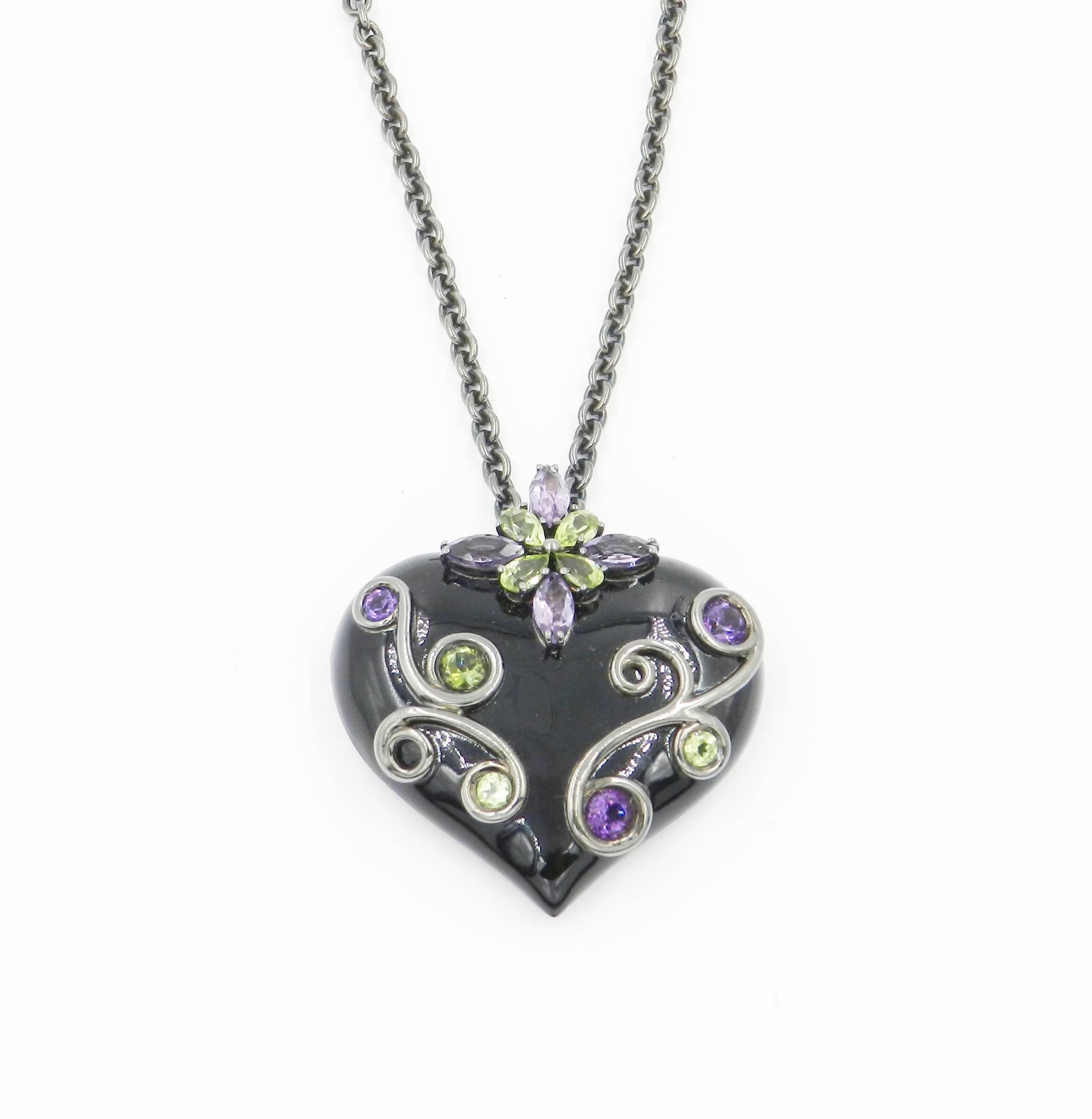 Originally designed across the millenium this fabulous chain with pendant is in silver and features a total of carat 1.09 of round  peridot and amethysts. The pendant size is mm 40 x 35. The chain lenght is 50 cm. Handcrafted in Italy, from the