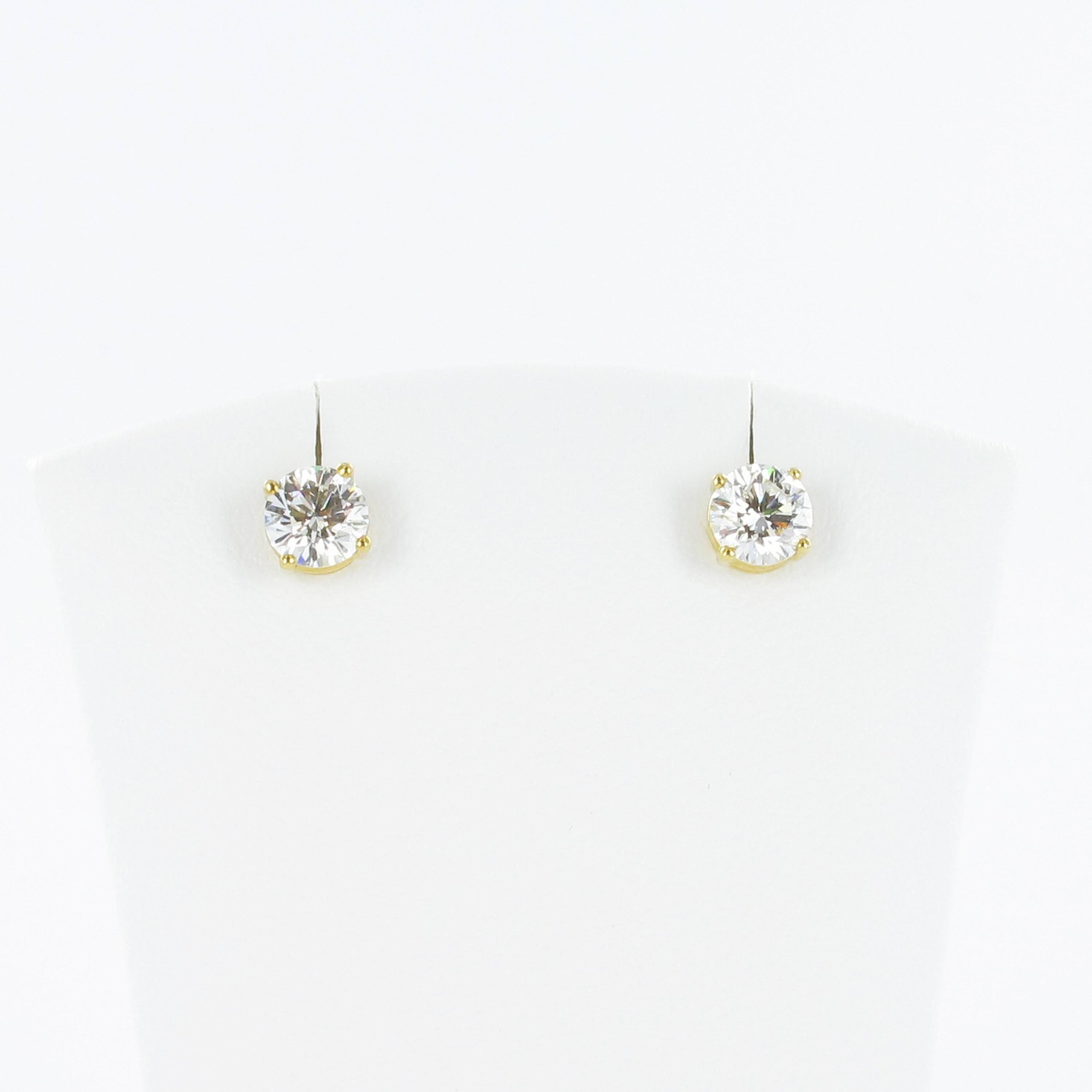 Classic solitaire stud earrings featuring two perfectly matched brilliant cut diamonds of 0.40 and 0.41 carats each of F colour and si1 clarity. Handmade Gübelin four-prong setting in 18 karat yellow gold with butterfly clutches.