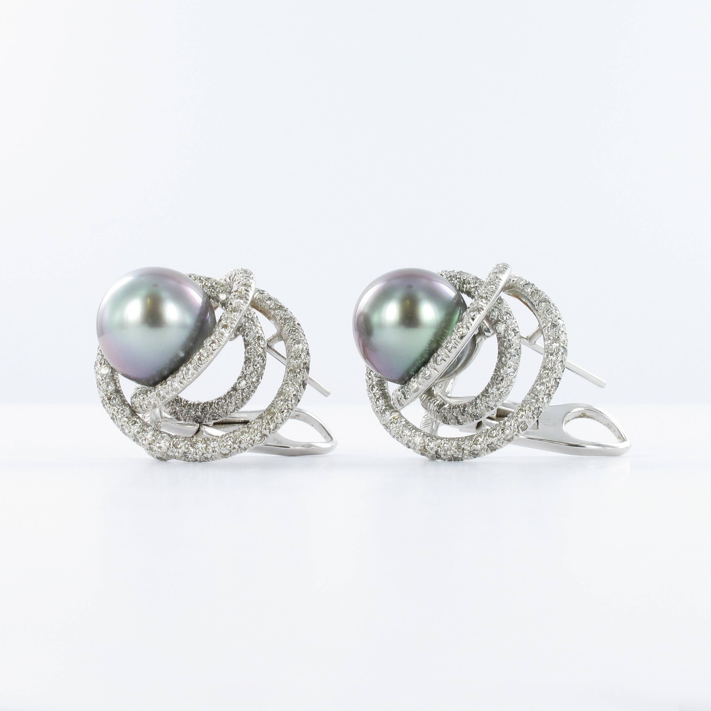 These earclips in 18k white gold feature two light to medium grey Tahitian cultured pearls of 12.0 mm diameter. The pearls are encircled by 364 delicately set brilliant-cut diamonds. Total diamond weight approximately 1.80 carats (G/H colour and vs