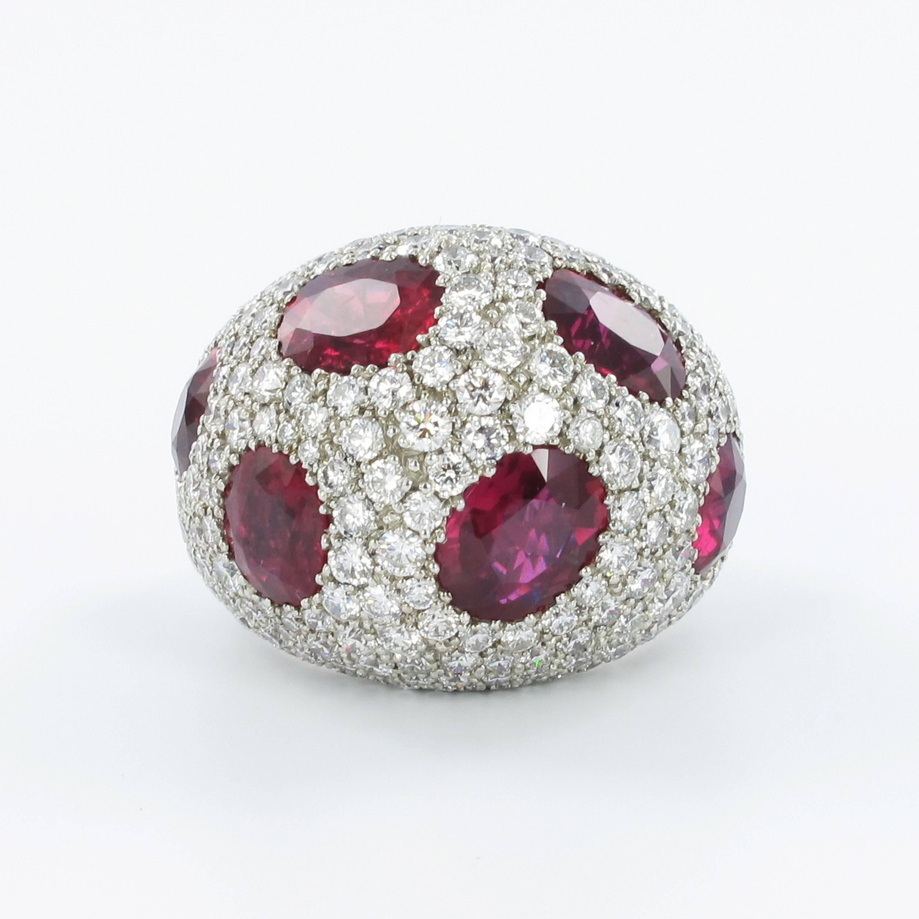 This voluminous dome ring is manufactured in platinum 950. The 6 certified, oval-cut rubies are of Mozambican origin and show no signs of any treatment. Total weight of the rubies is approximately 12 ct. The ring is completed with 233 brilliant-cut