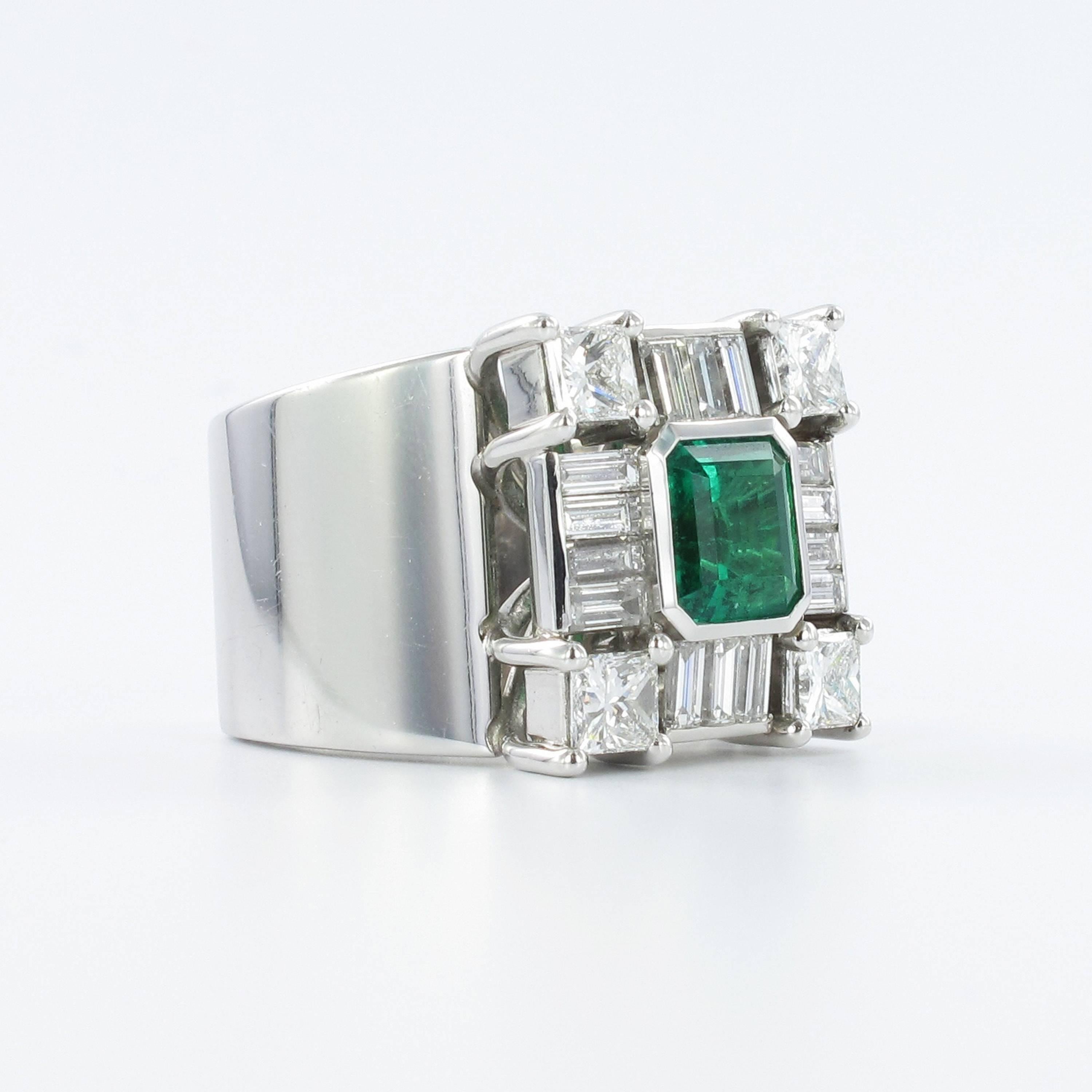 Emerald and diamond ring in 18k white gold. Set with an octagonal step-cut emerald with an approximate weight of 1.94 carats, encircled by four princess cut diamonds and 14 baguette cut diamonds with an approximate combined weight of 3.00 carats, G