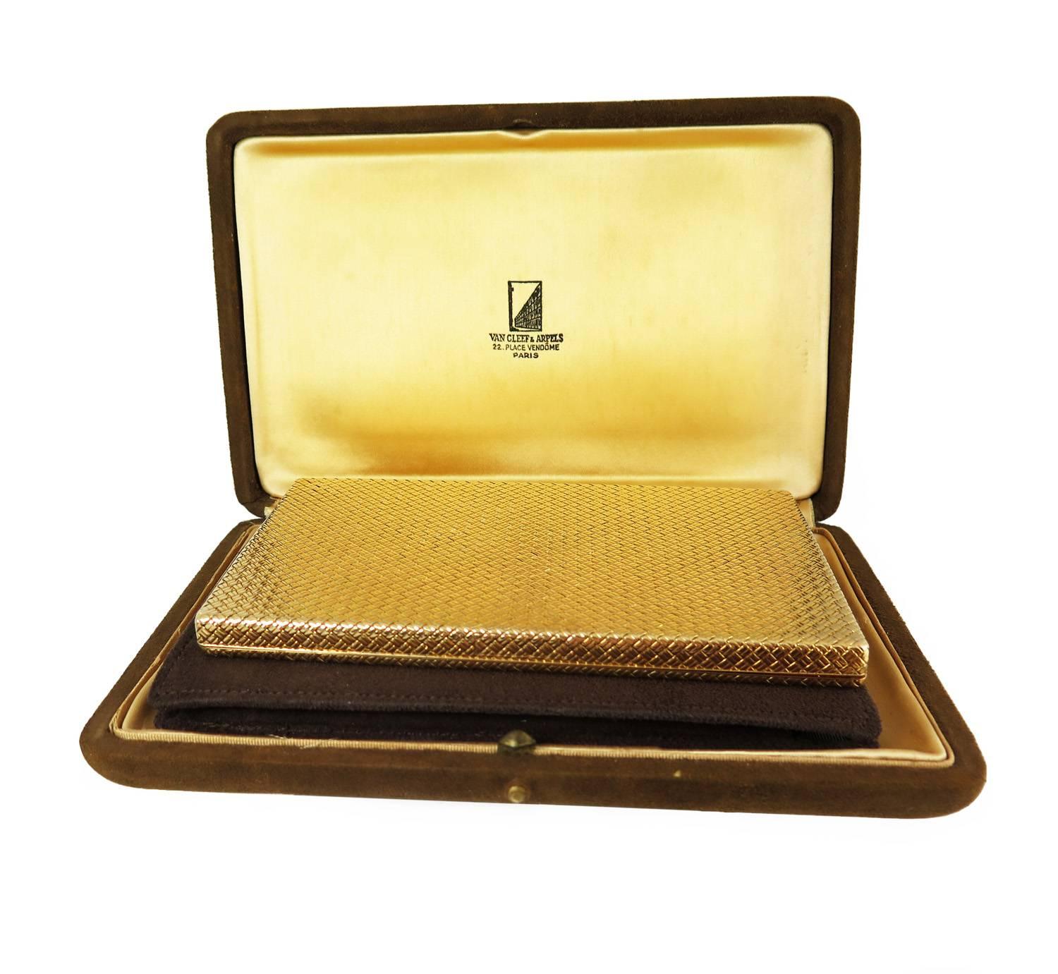 A slim, elegant modernist 18k yellow gold box with textured basketweave design, by Van Cleef & Arpels. Signed, with two inventory numbers and French hallmarks. In original suede pouch and fitted box. 