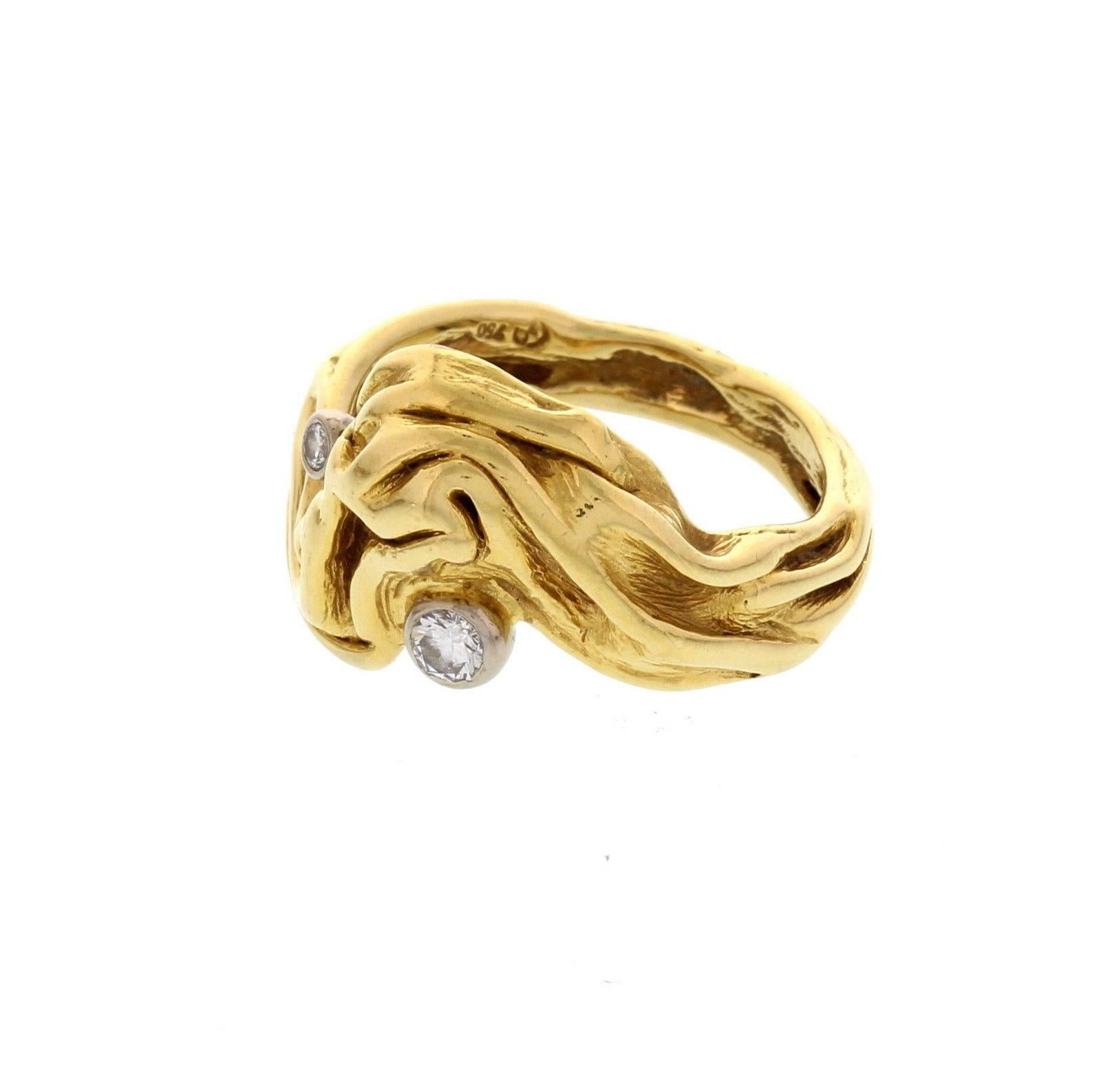 A modernist ring hand crafted in 18 k yellow gold, accented with two diamonds by Gilbert Albert. Circa 1970's. Marked with maker mark and 750.
Ring size:  6.75. Weight: 7.8 grams. Measured: 0.88 inches x 0.88 inches x 05 inches.