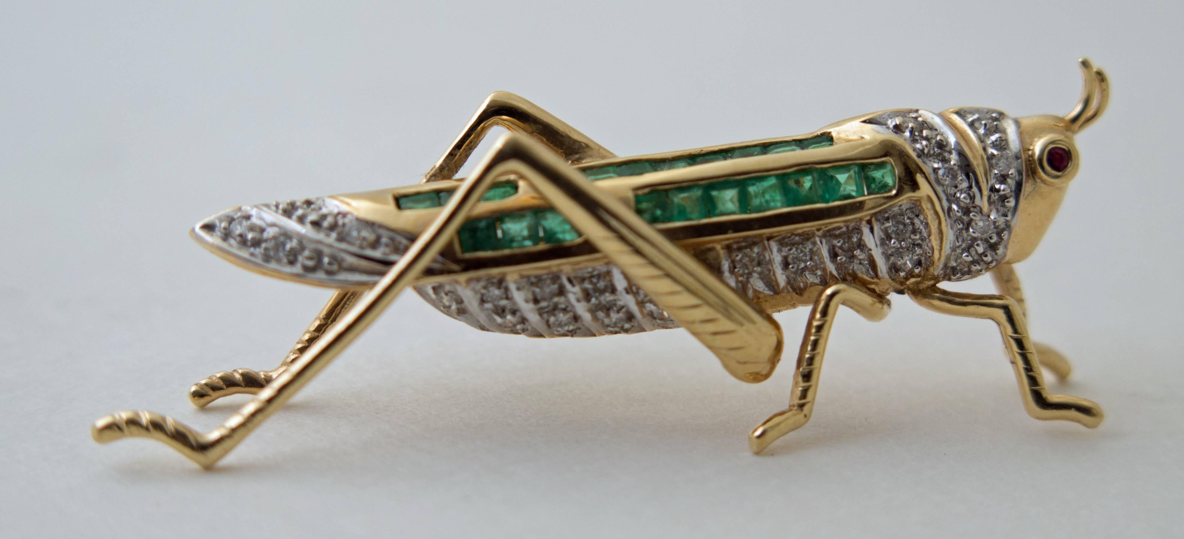 A beautiful pin in a shape of a grasshopper handcrafted in 14K yellow gold with 21 emeralds weighting approximate 0.9 carats, 22 round cut diamonds weighting 2.2 carats and ruby eye.
measured 50 mm x 22 mm. weight 7.8 grams.