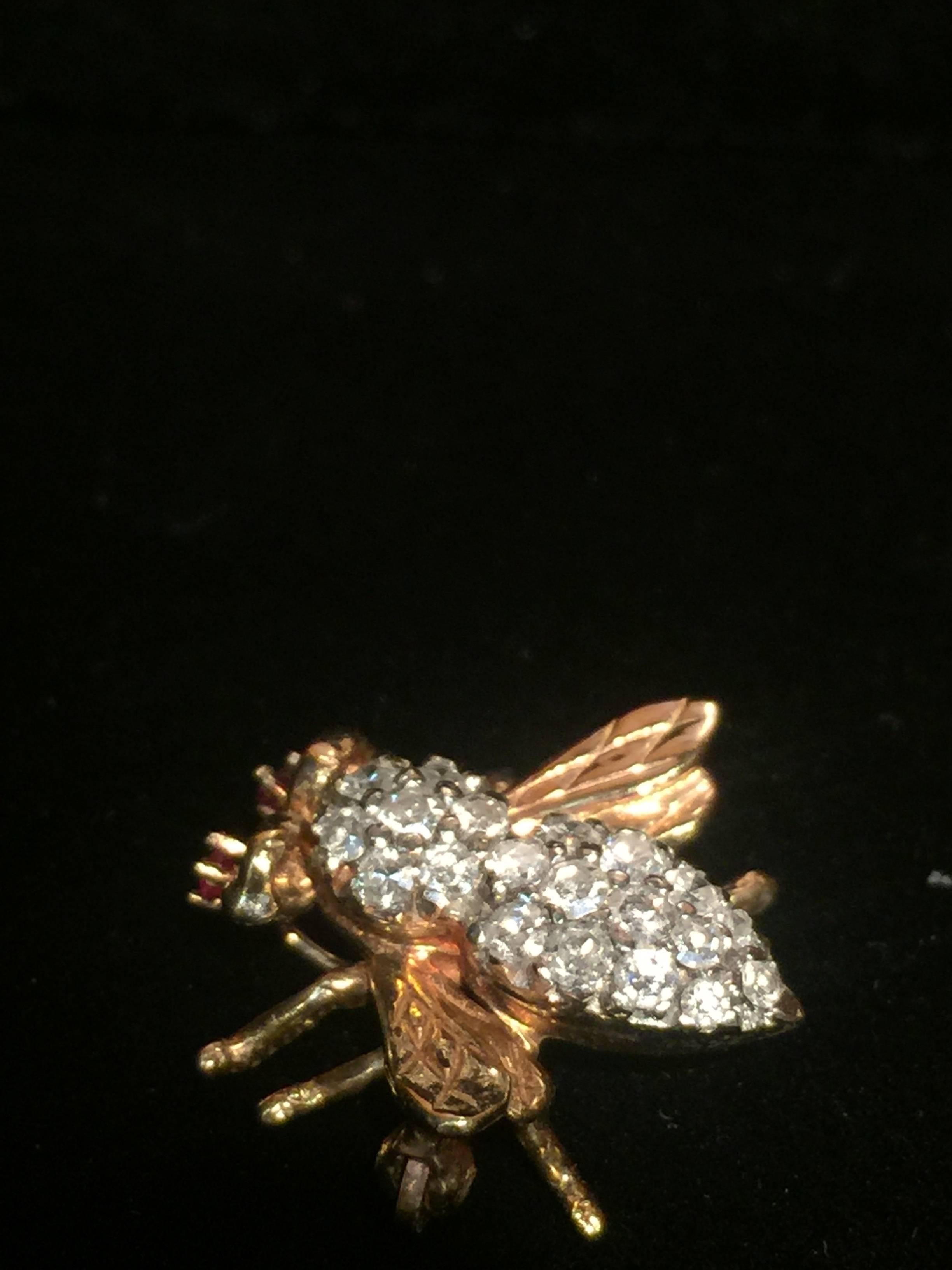 A fine classic vintage bee brooch with diamonds and ruby's.The body and head are decorated with diamonds.The eyes feature prong set rubies.  14k yellow gold. Total diamonds weight is approximately 0.3 carats. Measures 3/4 in x 3/4 in;. Weigh 4.7