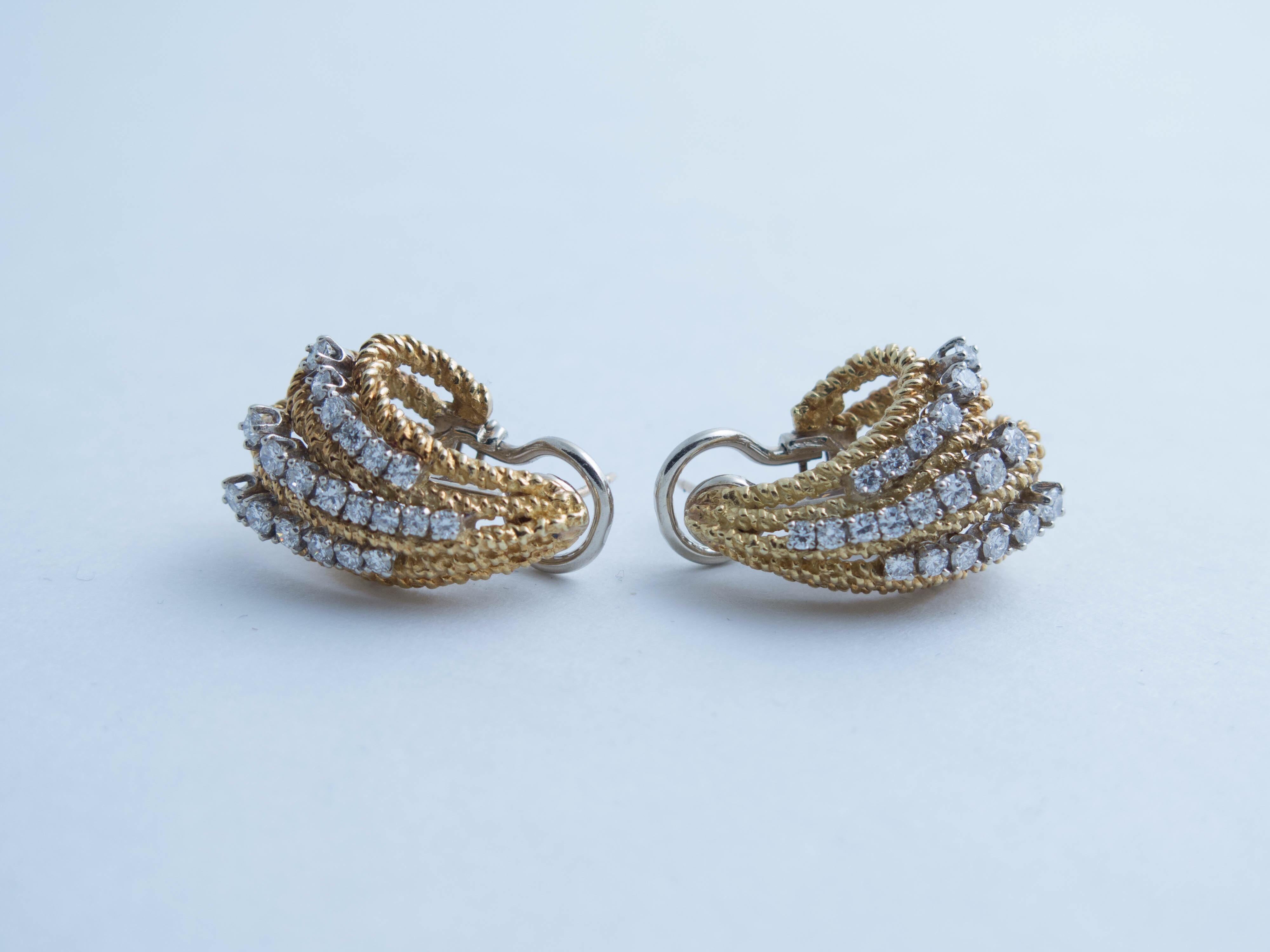 Pair of circa 1960's organic-form diamond earrings crafted in 14 K yellow gold. There are 40 round brilliant cut diamonds total weight 1.58 carats, G-H color, VS in clarity. Diamonds are set in white gold. Notched post with omega clips. Total