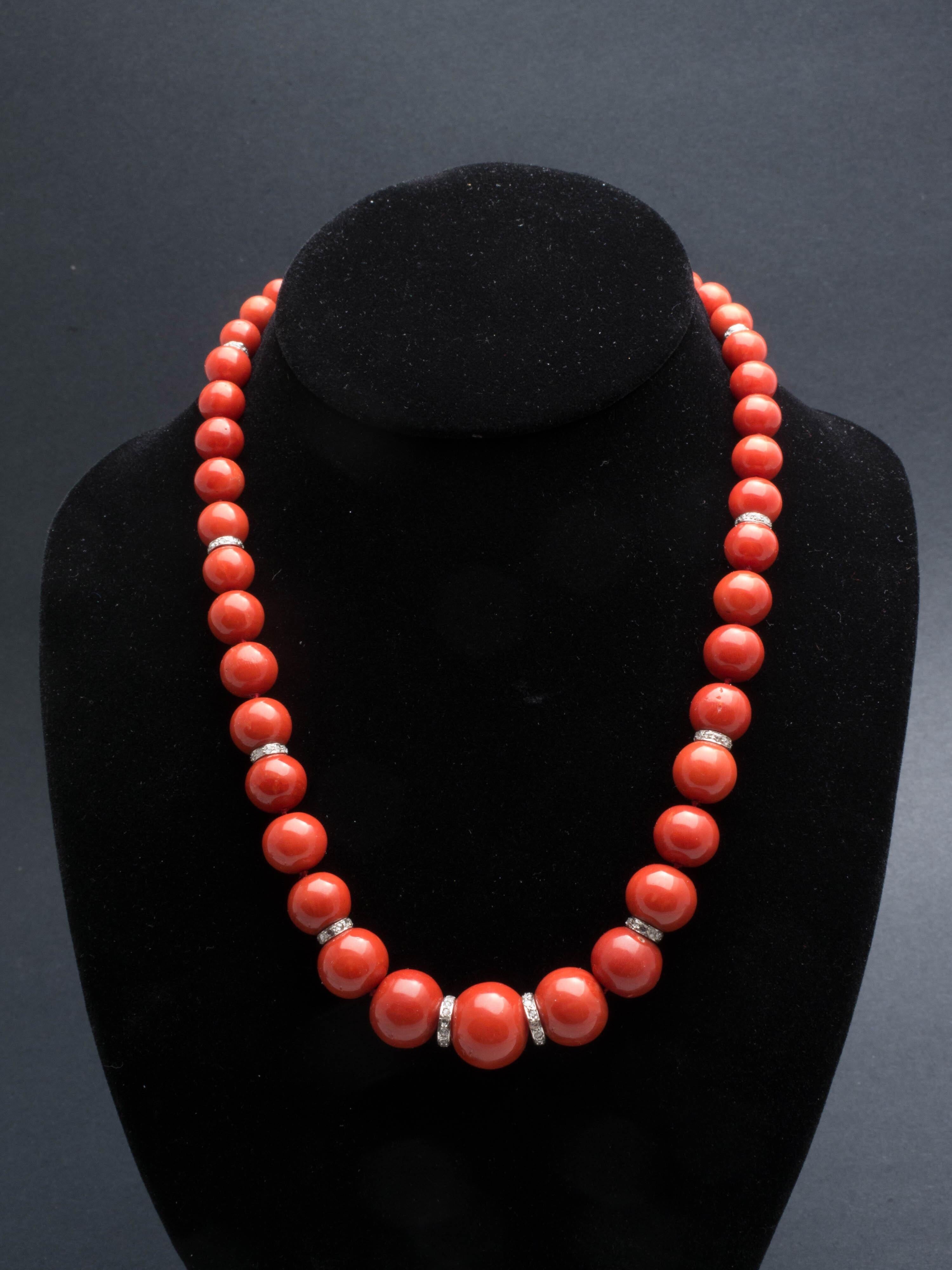 Beautiful natural red coral bead necklace with 12 diamond roundels spacer. Platinum clasp with 5 carved emerald, 1 jadeite and 8 diamonds. Coral beads are ranged from 15.5 mm diameter to 7.35 mm. Total length of necklace is 18.75 inches. Total