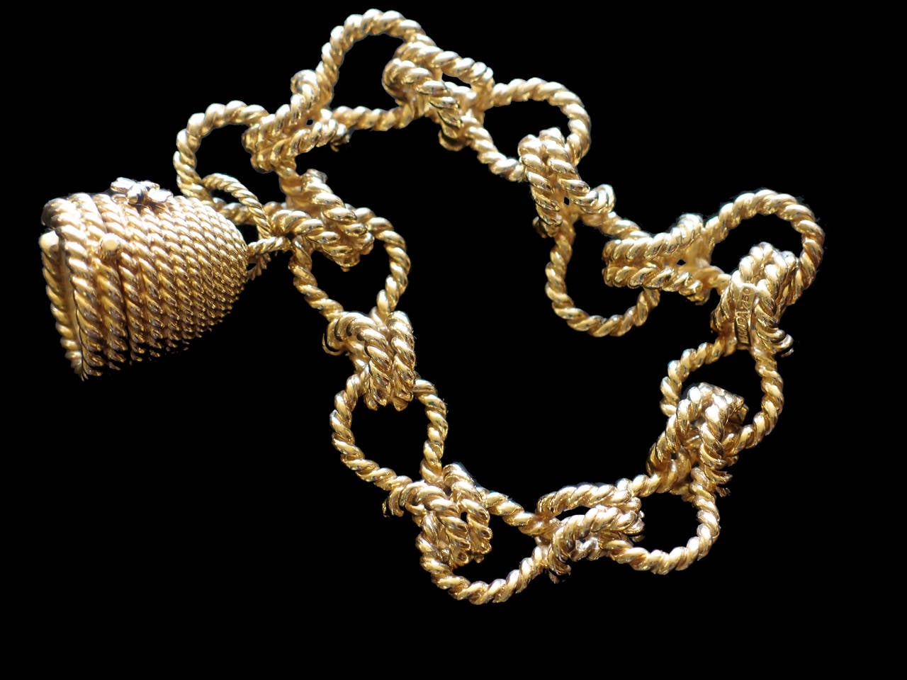 A heavy and gorgeous 18k gold rope link bracelet with an attached beehive form pendant watch.

Classic, fun and elegant.