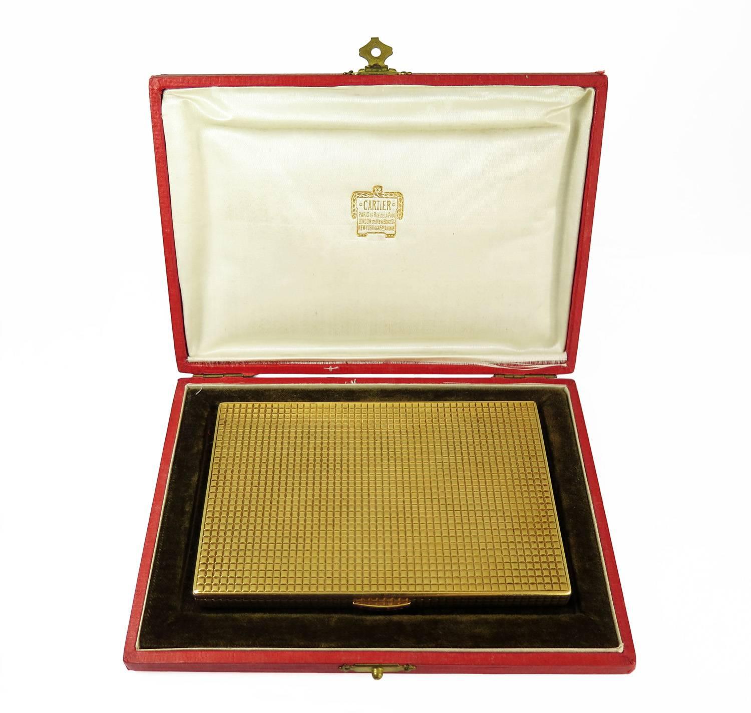 A handsome geometric patterned 18k gold box by Cartier, Paris. The clasp set with seven faceted rubies. Signed 