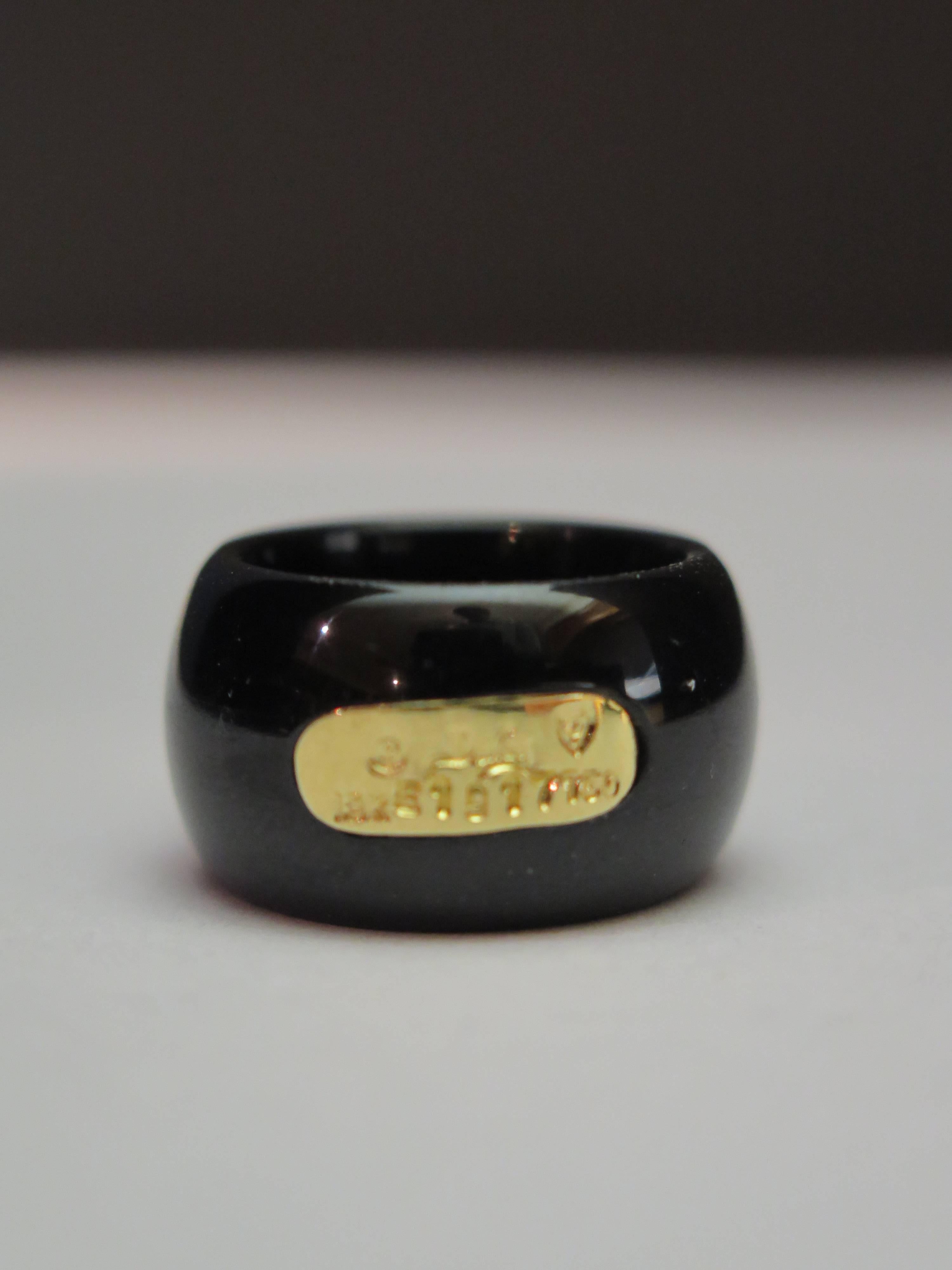 A beautiful Henry Dunay's black onyx wide band ring with full cut diamonds melee in 18K yellow gold. numbered and marked. Size 5-1/2. 