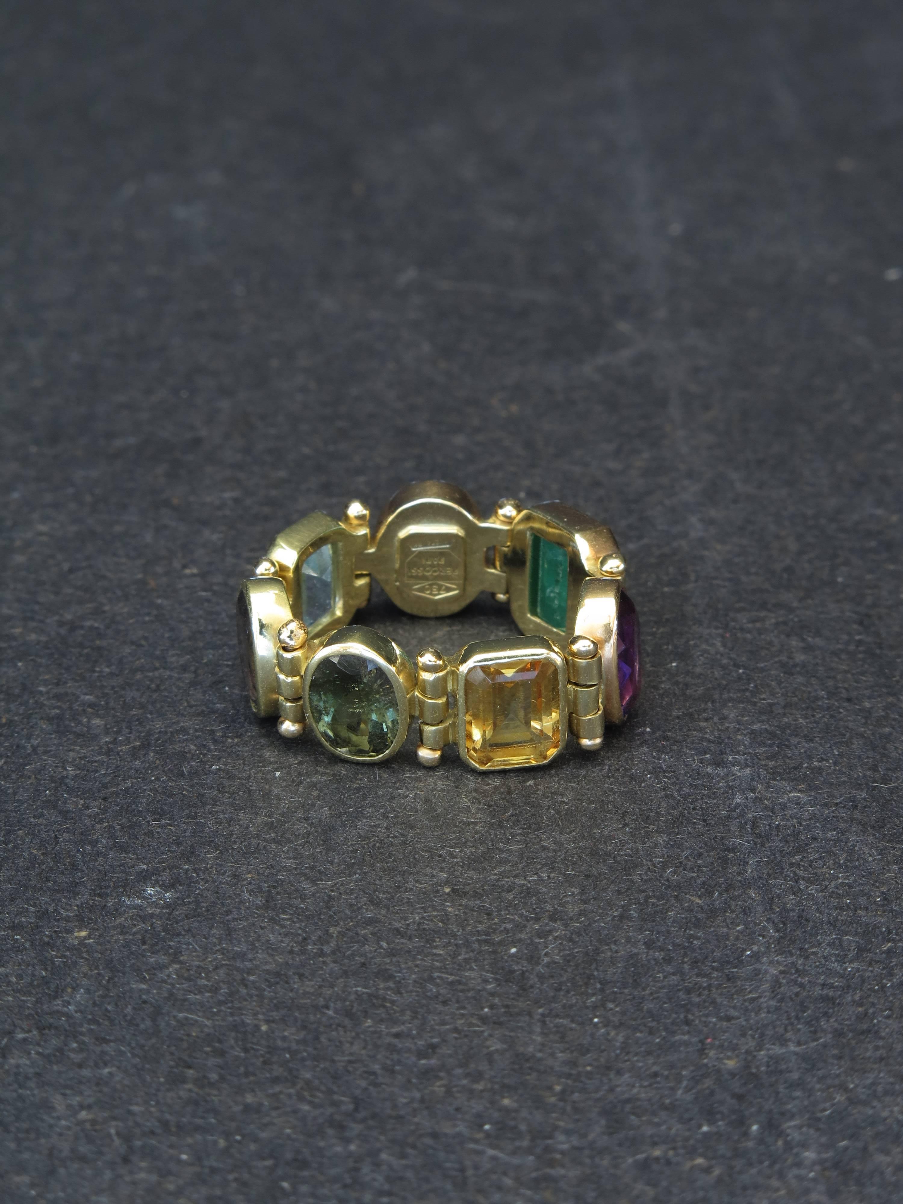 A beautiful flexible 18K yellow gold band ring by Percossi Papi of Rome, Italy. It consists of 7 different color stones. Signed.
Size 7.5. Can not be resized.
Stones are Emerald, sapphires, aquamarine, amethyst, citrine.