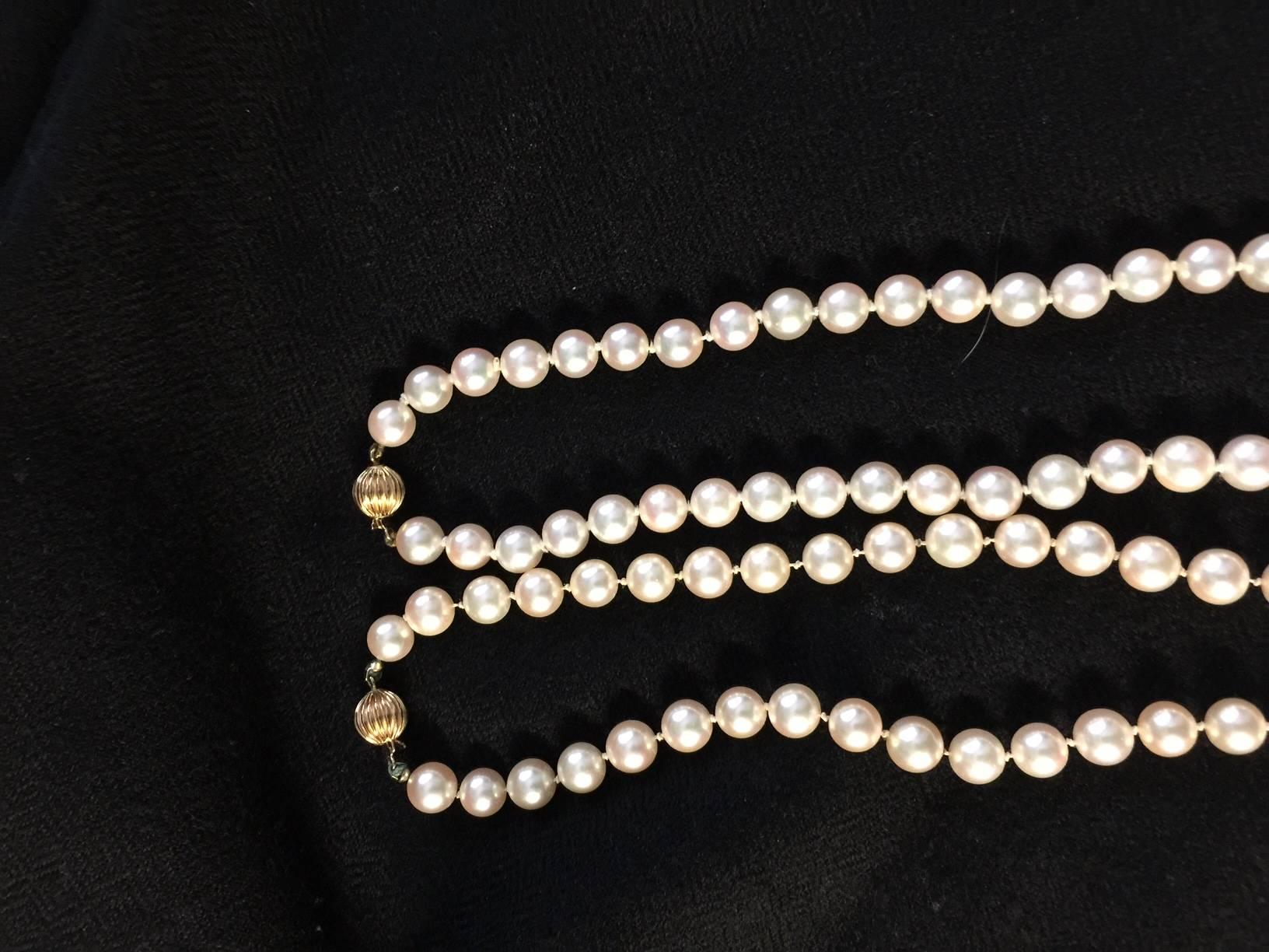 2 Fine grade A 30 inches long Akoya salt water pearl necklaces with good luster. Pearl sizes are 7mm to 7.5mm. Total weight of 121.4 grams including 14 yellow gold fluted clasps. Each necklace contains 113 pearls and 115 pearls.

