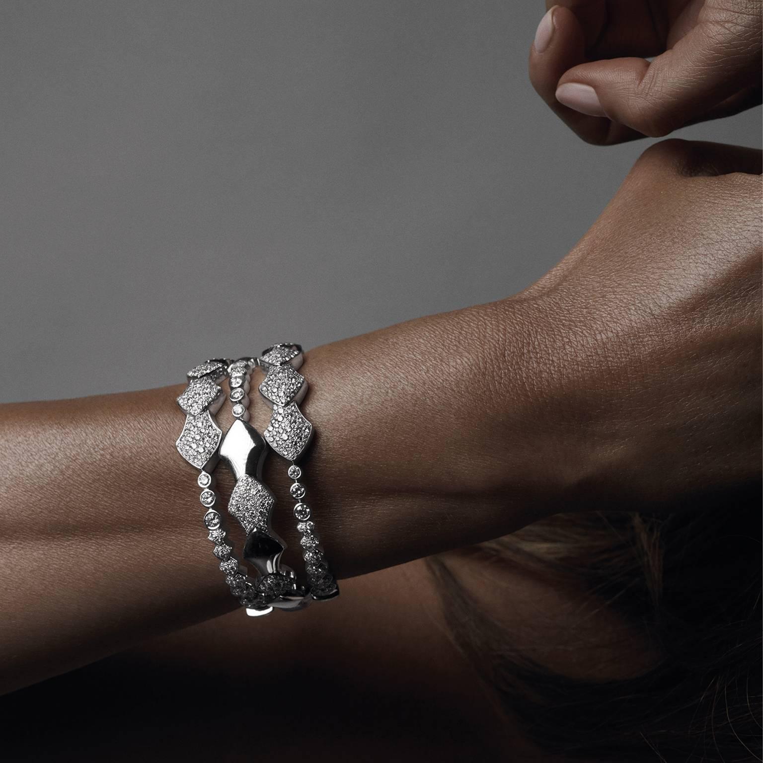 18K White Gold AKILLIS Python bracelet half-set with white diamonds 
Diamonds (cts): 1,76

With the Python collection AKILLIS takes the bold graphic power of snake scales and weaves them into a modern evocation of a tattoo that hugs the skin.