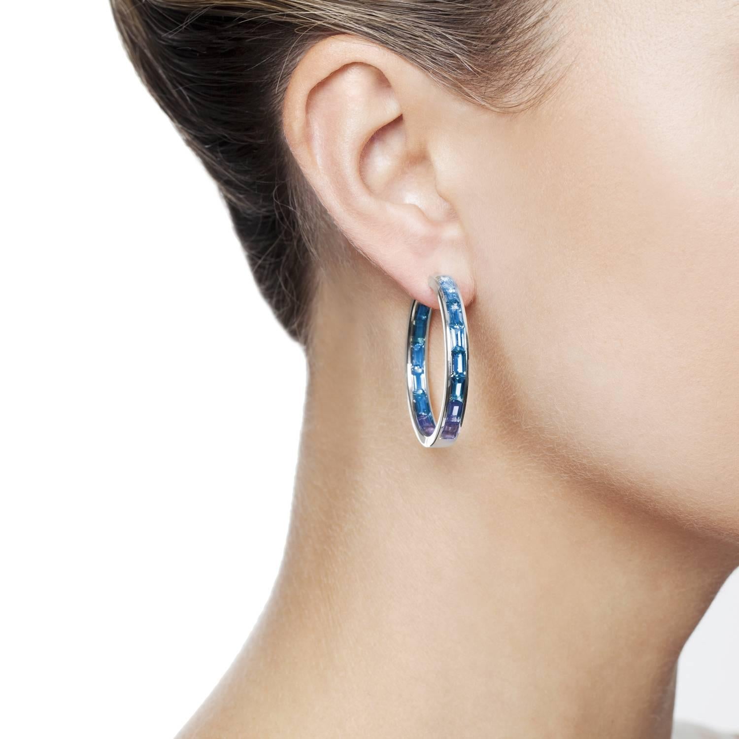 Beautifully made Daou hoop earrings created in harmoniously graduated baguette gemstones perfectly set to allow light to refract through creating flashes of beautiful colour. Like a stained glass window the setting allows light through the gemstones