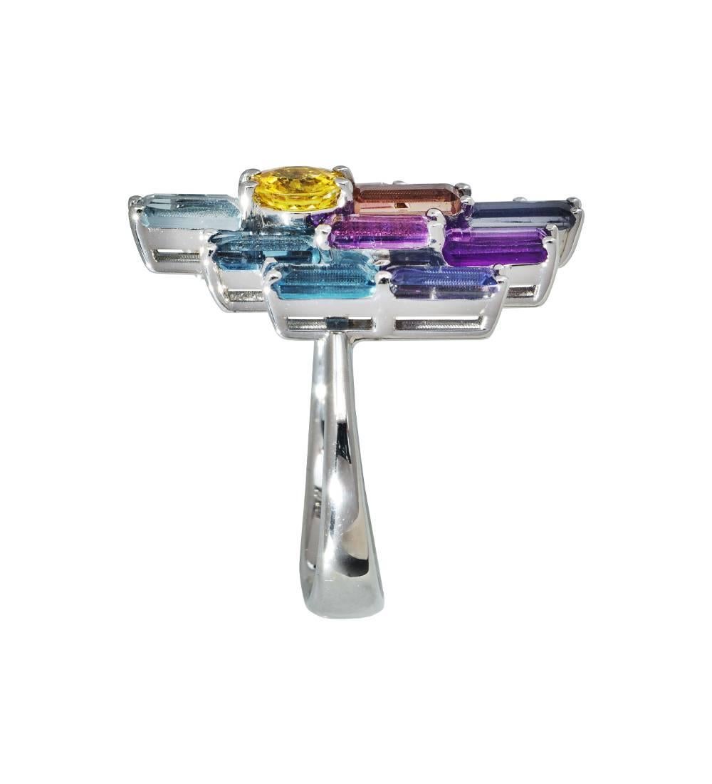 A large impressionist style cocktail ring by Daou with the cool colours of dawn and dusk created in a harmonious palate of faceted stones, set in such a way at different heights to let light in and diffract all the colours within. 

Made in Italy,