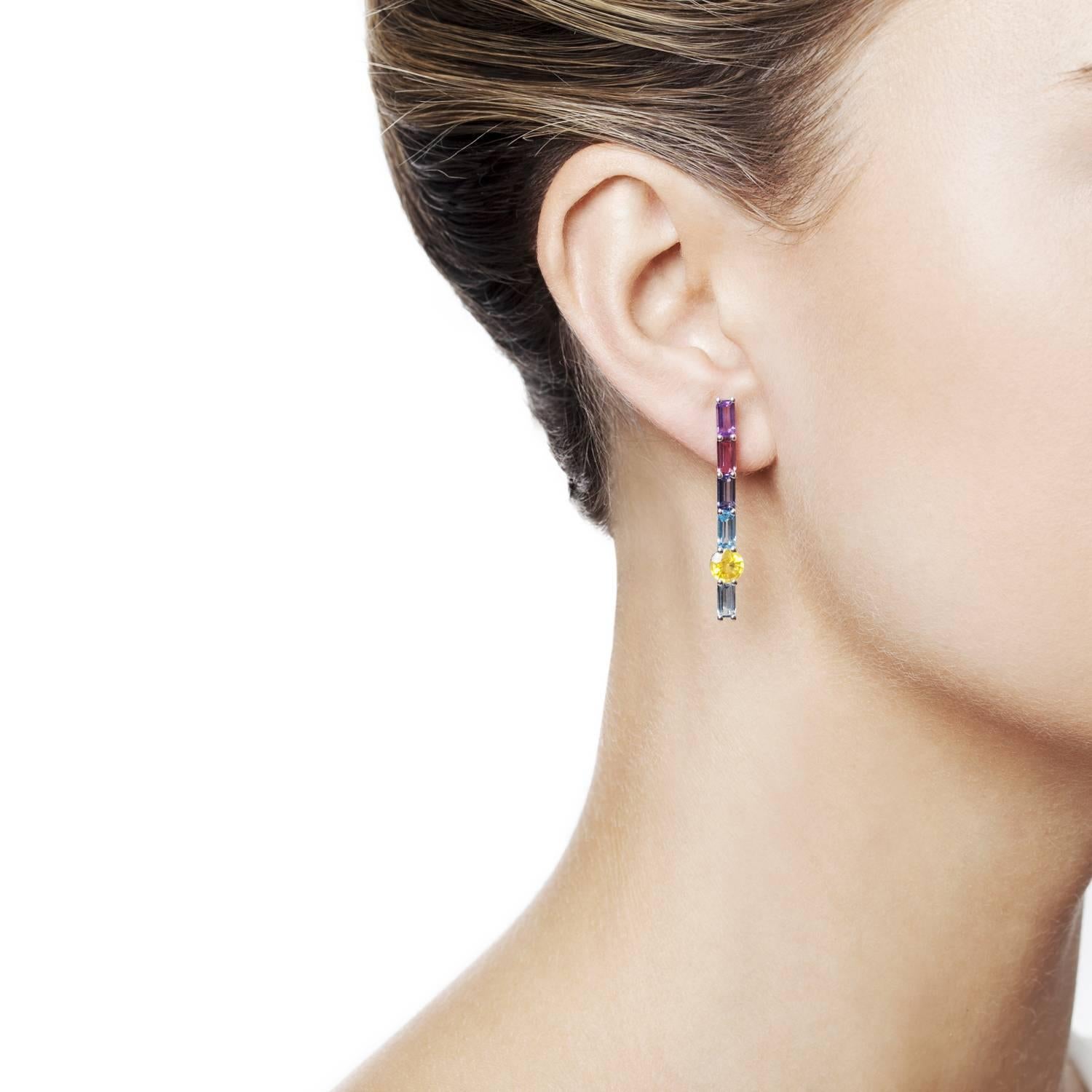 Daou Sapphire and baguette genstone line drop earrings in a modern Art Deco Daou style. A a harmonious palate of faceted gemstones. Eye catching and evocative in white gold to highlight the cool brightness of the dawn and dusk. Pictured other pieces