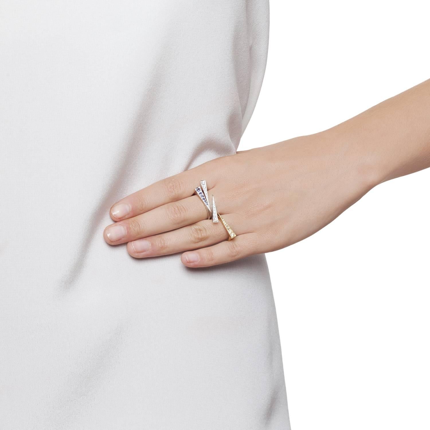 The Spark Ring in 18 carat White Gold and Iolite blue gemstones is a delicate modern, elegant and refined design. The signature Daou Sparks from the collection of delicate stacking rings and convertible earrings takes the perfectly proportioned 7