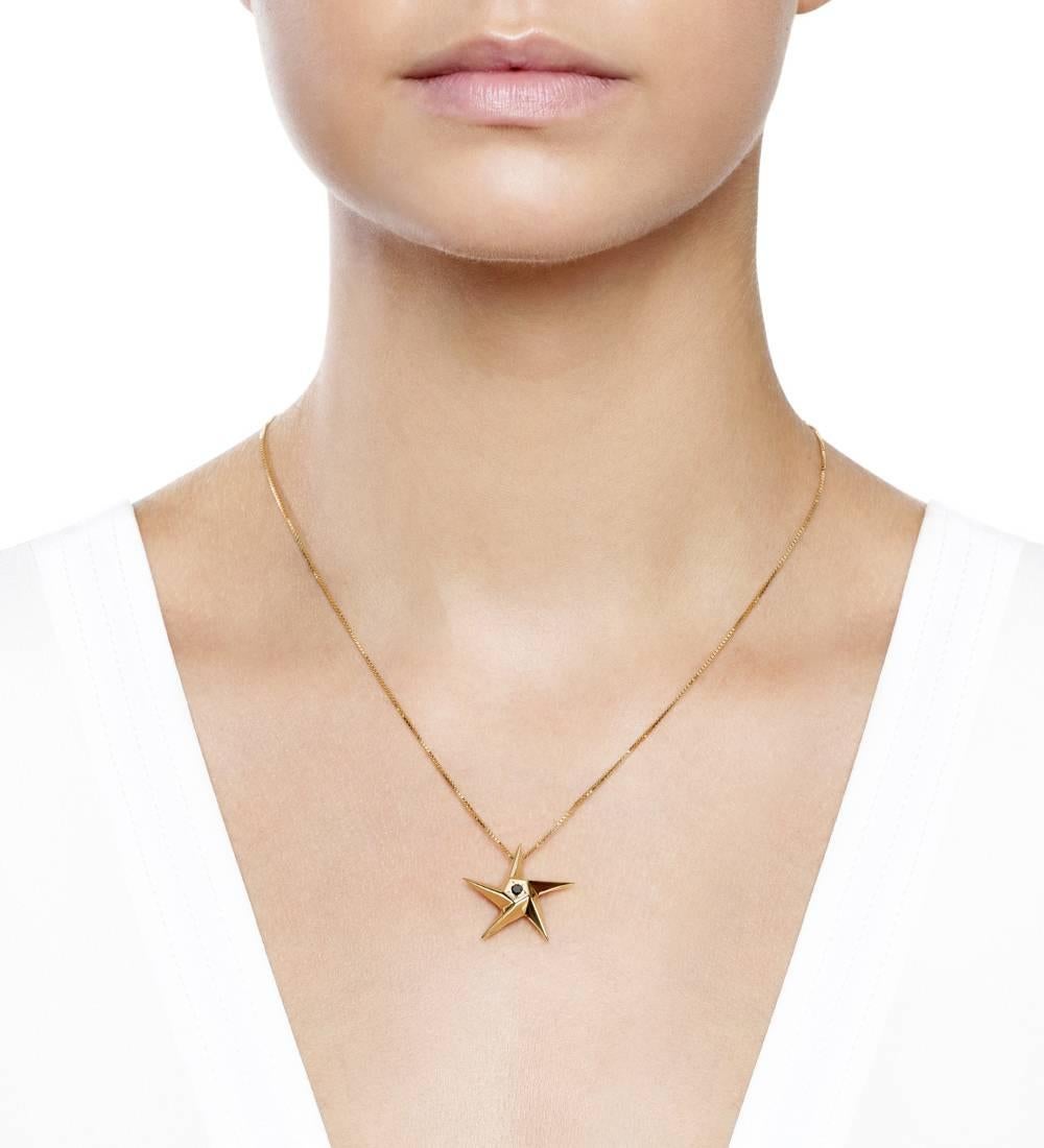 The iconic contemporary Daou star pendant necklace in Black Diamond and Yellow Gold in the medium size. The Star collection features geometric Art-Deco inspired Stars in an array of sizes and colours of gold and may be set with your choice of