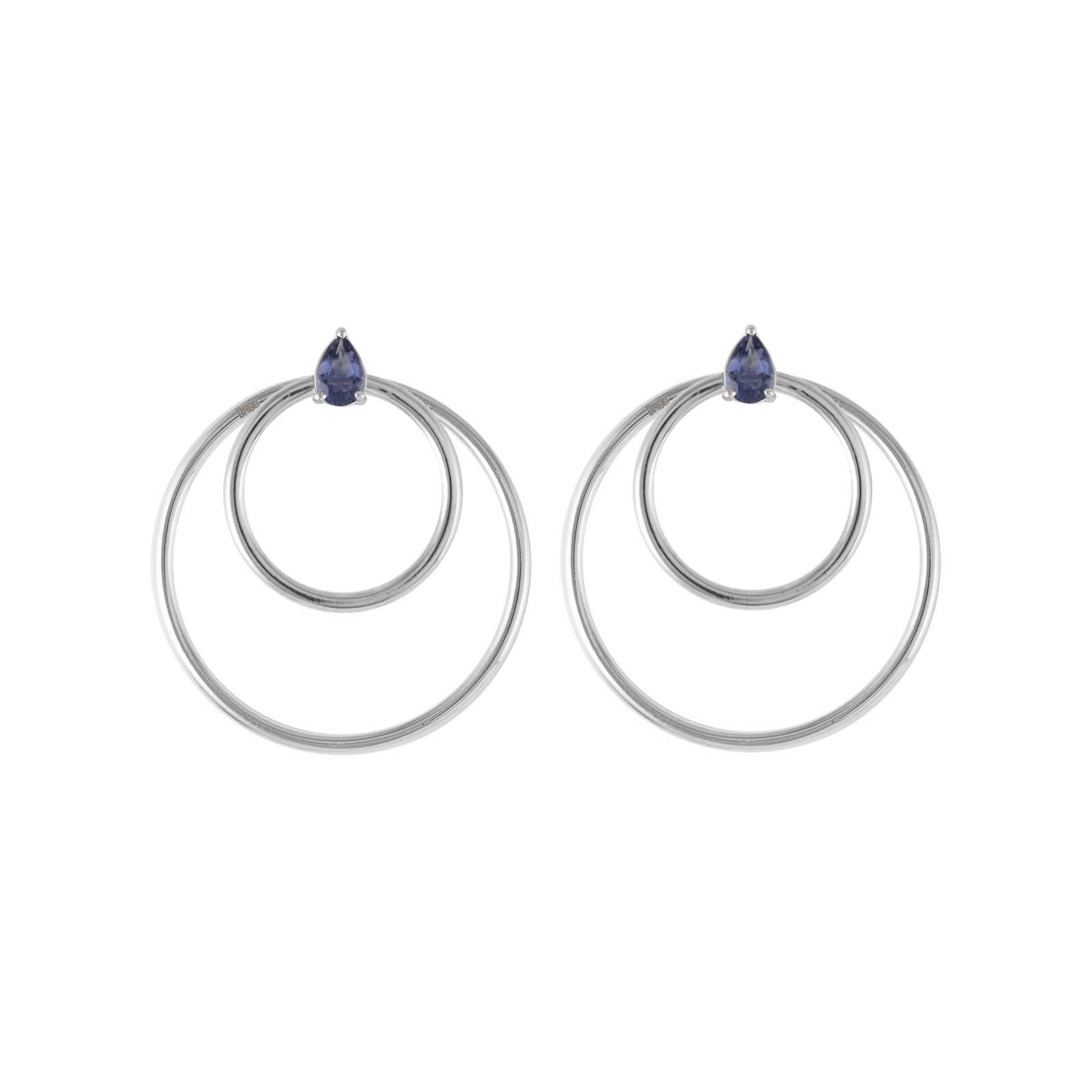Iolite and white gold small front facing hoop earrings. Simple chic earrings set with pear cut iolite gemstones in 18 karat white gold. Perfectly geometrically balanced to be pleasingly elegant and flattering. A perfect complement to the Quanta
