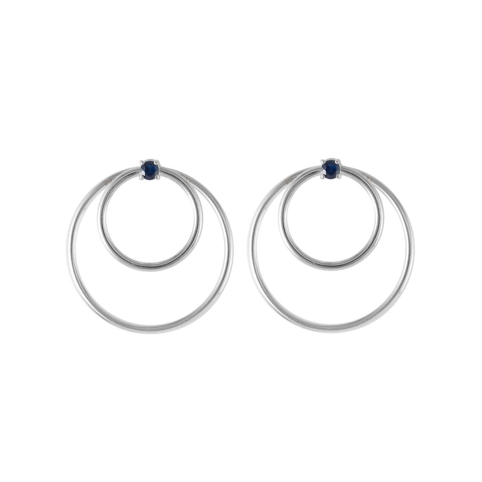 Sapphire and white gold small front facing hoop earrings. Simple chic earrings set with round brilliant cut blue sapphires in 18 karat white gold. Perfectly geometrically balanced to be pleasingly elegant and flattering. A perfect complement to the