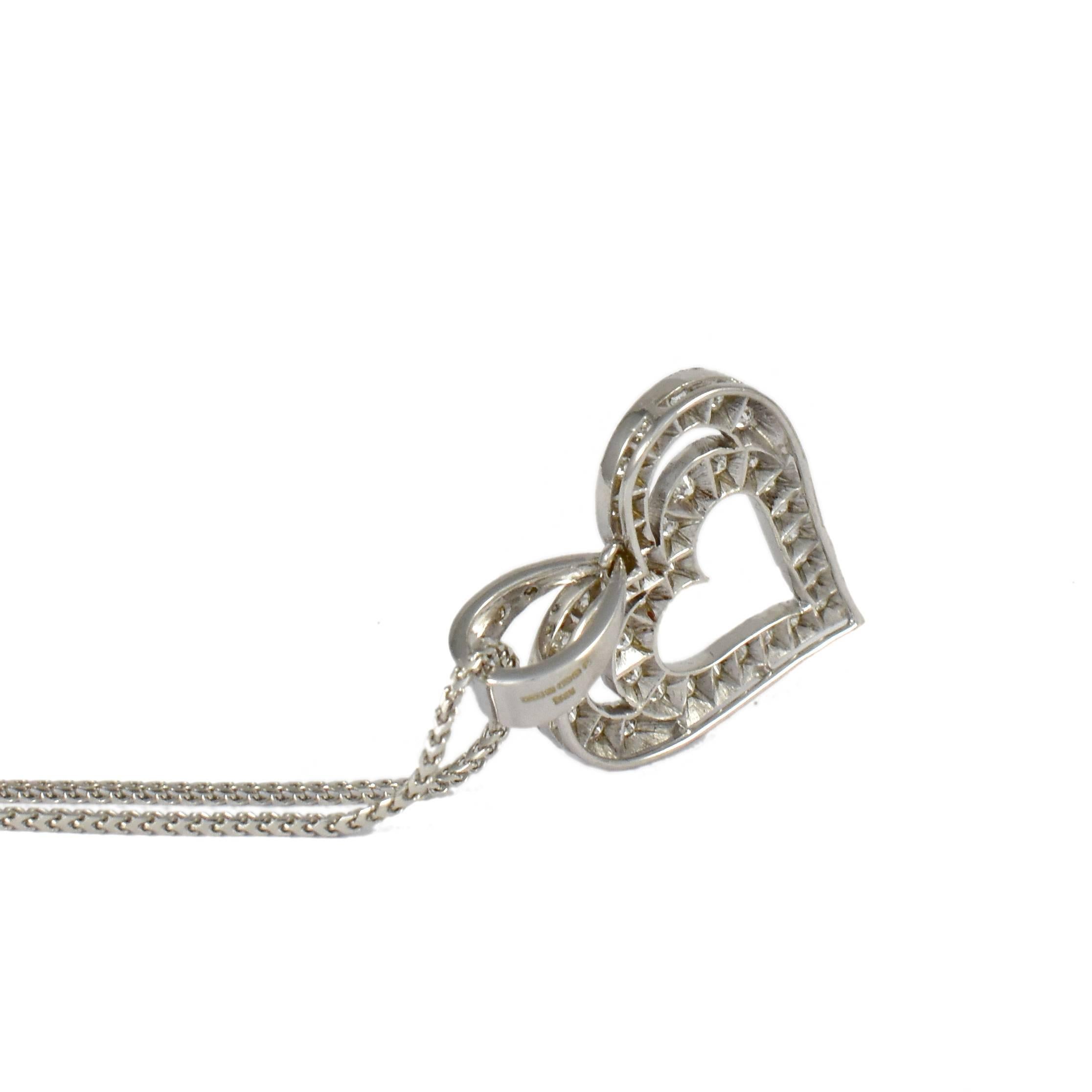 The Heart in Heart pendant necklace in 18 karat white gold is set with round brilliant diamonds and comes with a matching 18 karat white gold chain. A modern timeless pendant cleverly uses considered negative space to highlight the detail of the