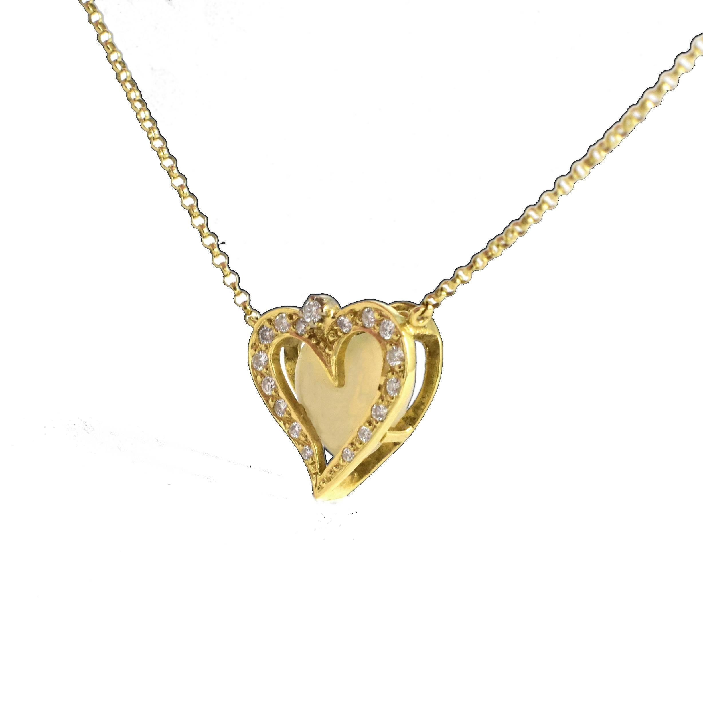 A detailed diamond heart pendant necklace with an opal centre set in an 18 karat yellow gold frame. The design is alive with life and happy movement in its shape. Hand made with a special tiered setting made to envelop a special stone center, here