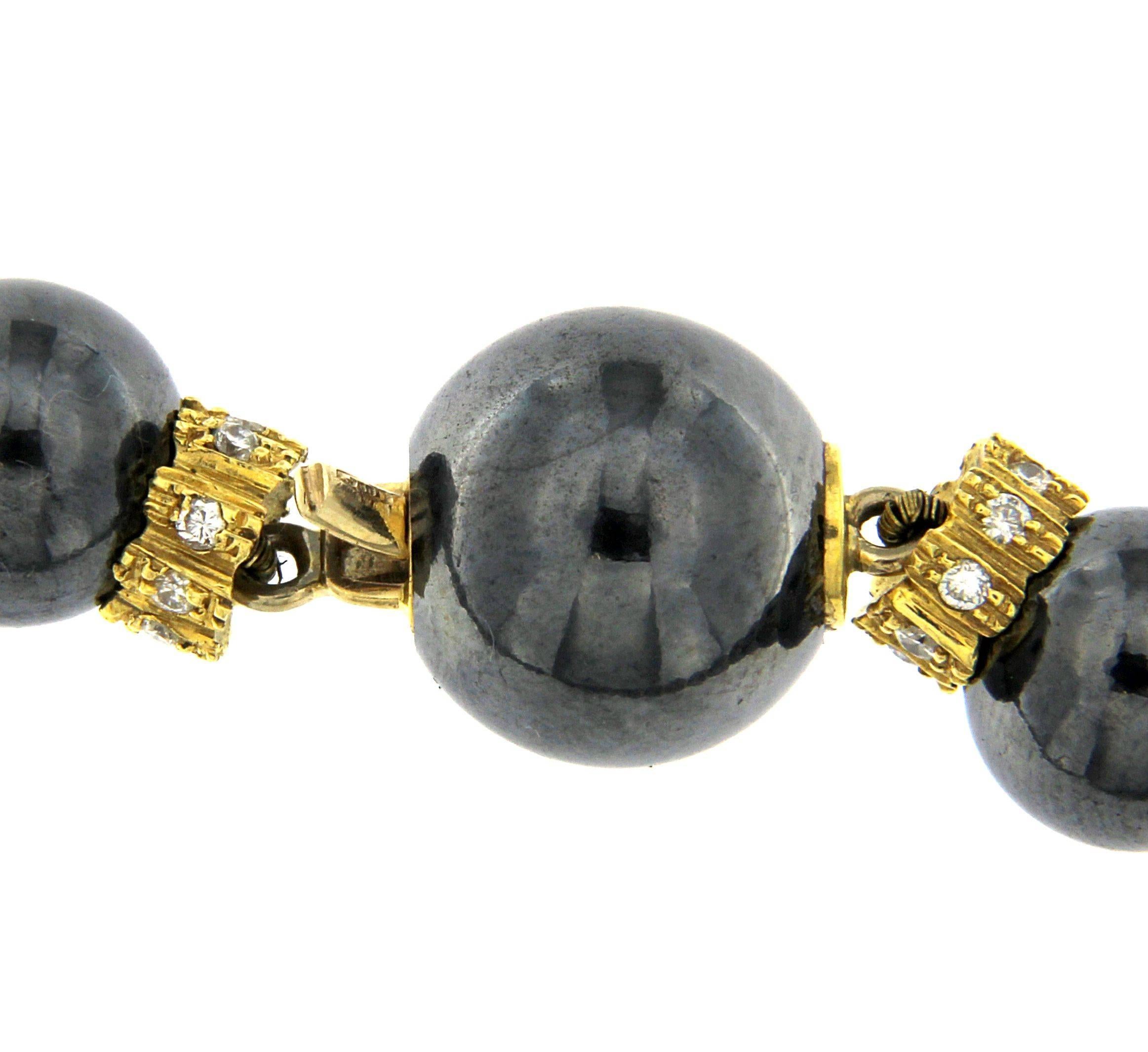 Elegant and stylish necklace inspired to the fashion in France in the 1970's. A big strand of hematite beads connected with many beautiful diamond and yellow gold elements. Versatile - can be worn as a regular necklace which gives more casual look