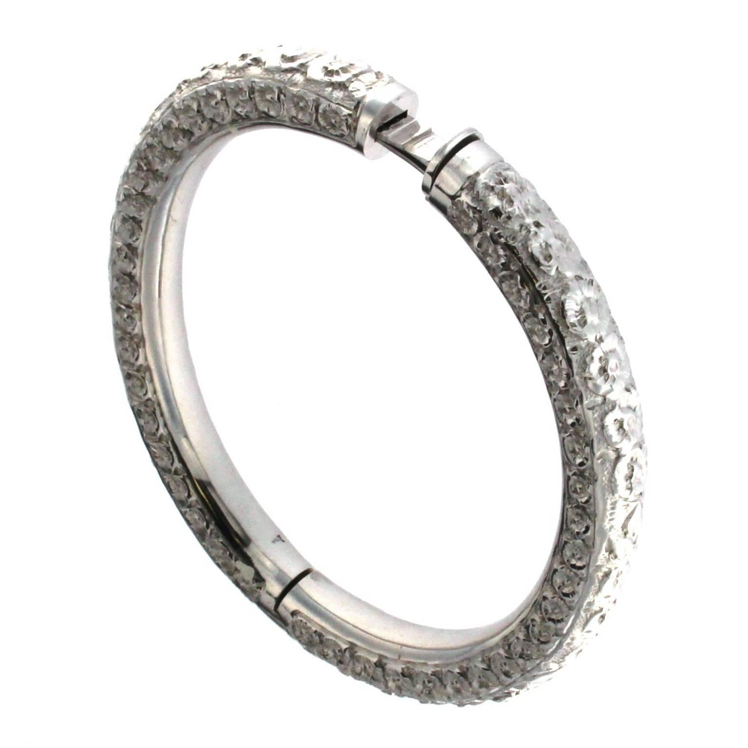 Introducing a gorgeous bracelet from the Roserosse Collection, crafted in 18 karat white gold and designed to perfectly fit the oval anatomy of a woman's wrist. This exquisite piece is embellished with intricate hand chiseling, a nearly disappearing