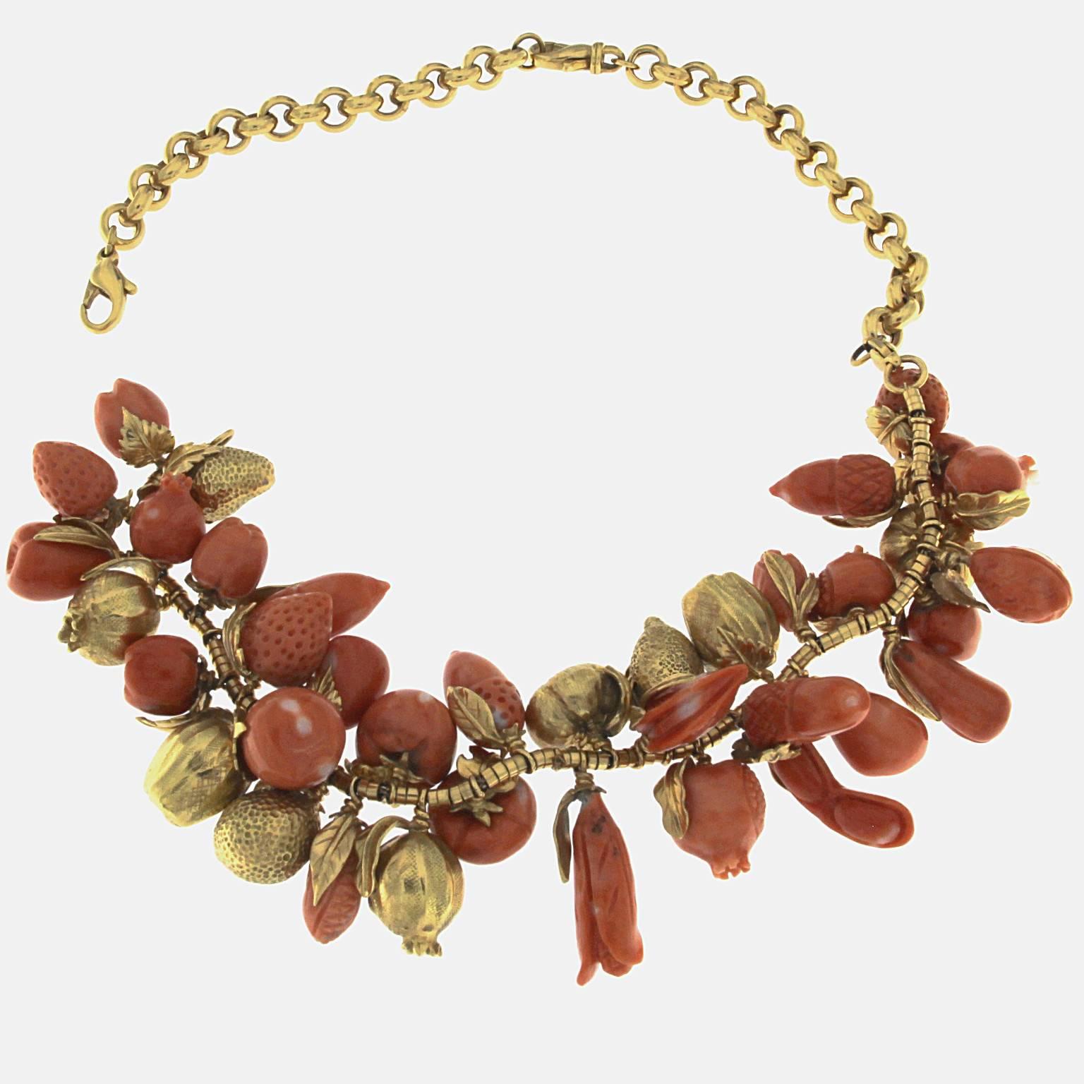 Coral and 18kt yellow gold fruit necklace
The front part can be worn as a bracelet taking out the back since it has 2 clasps. 
Total weight of 18 kt gold: gr 124,70
Total weight of red coral: gr 66.00
Stamp: 10 MI, 750, ITALY