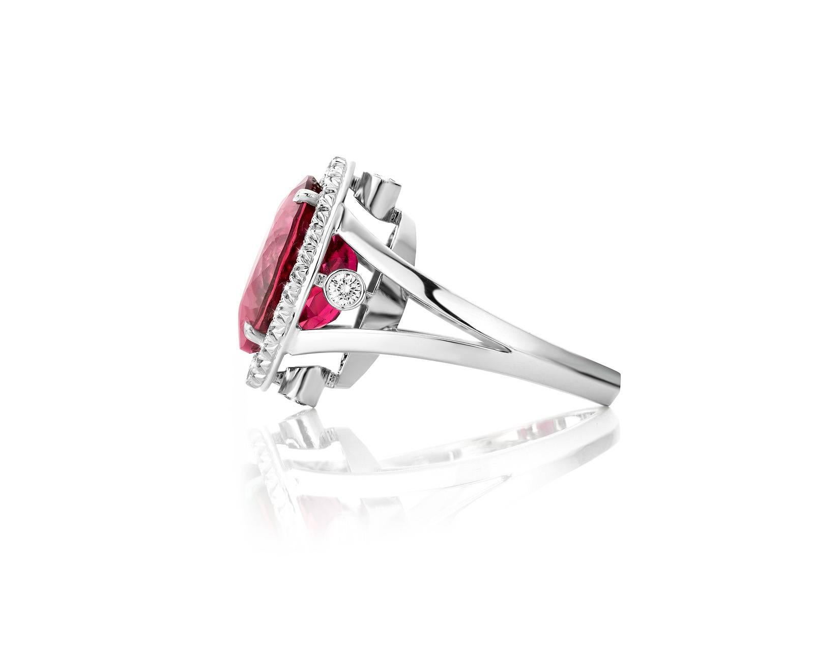 This white golden ring ( eighteen carat ) weighs 9,2 grams. 
Featuring a 9,35 carat of Rubellite surrounded by diamonds VS1 quality G color. 
One of a kind ring for the Lover of Quality !