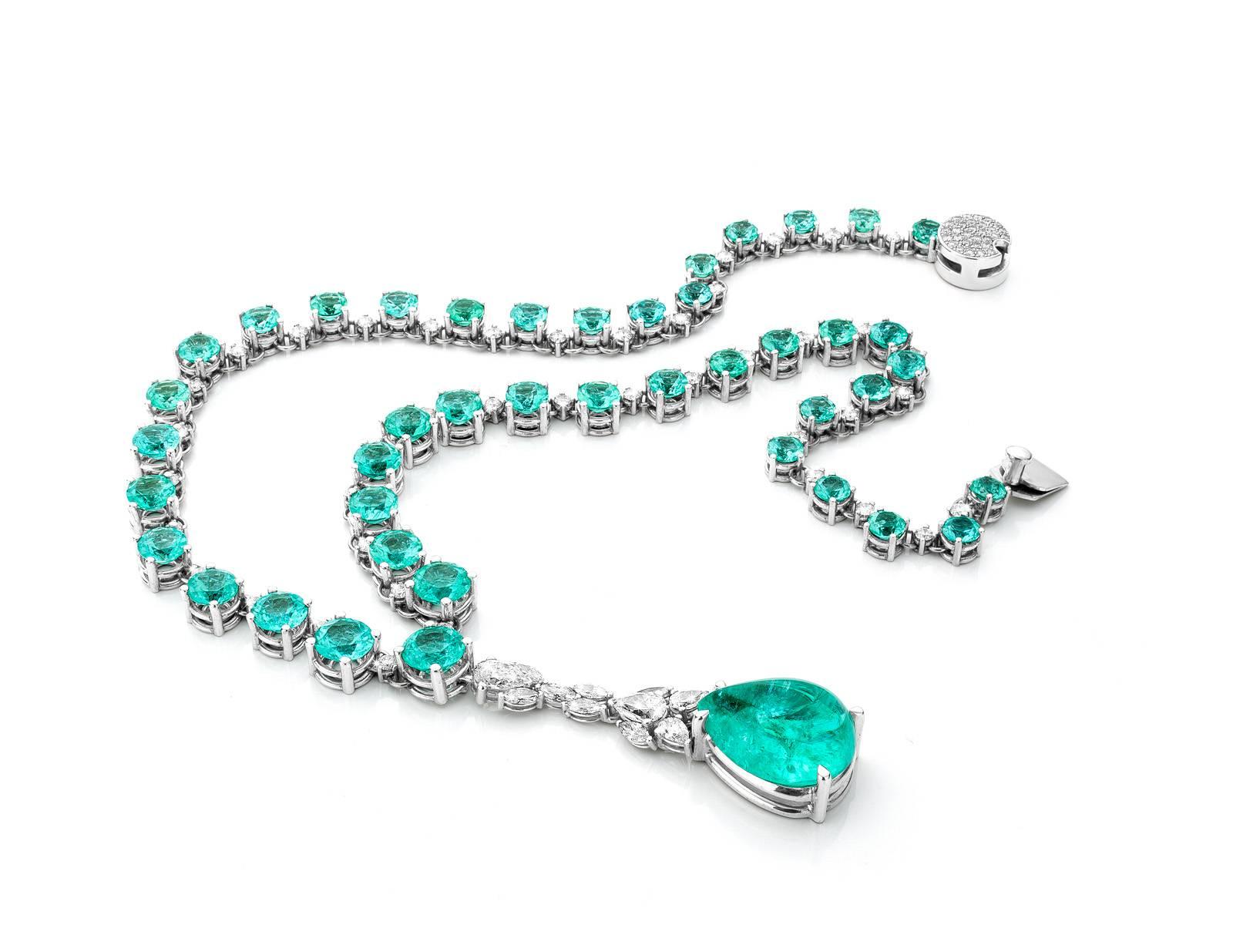 This one of a kind necklace made out of eighteen karat white gold is set 43 brilliant cut paraiba tourmalines weighing 34,83 carat and 42 diamonds weighing 2,49 carat. The detachable pendant is made out of 11 diamonds weighing 2,49 carat and one