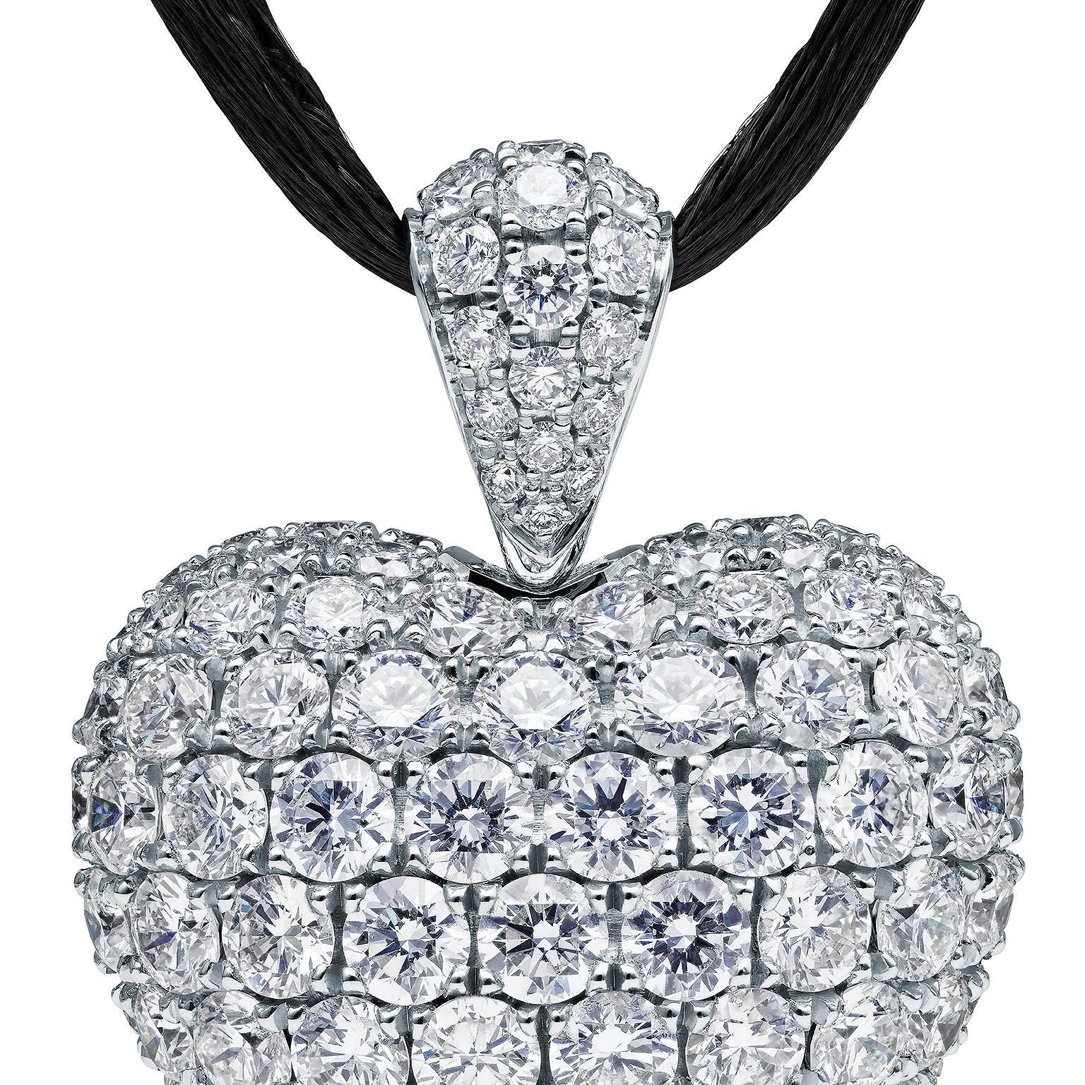 This magnificent diamond and 18 Karat white gold heart pendant designed by Towe Norlen in 2010, is shaped as a perfectly curved heart with a prominently rounded body. It has 179 hand set Top Wesselton (TW vvs) high quality diamonds. In total 7.55