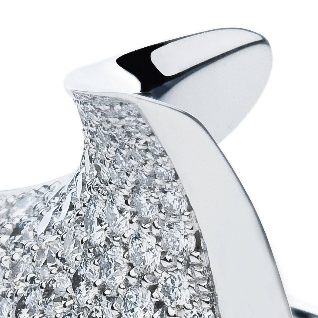 This elegant but extravagant right hand, or cocktail, 18 Karat white gold and diamond ring designed by Towe Norlen in 2002, has 170 hand set Top Wesselton (TW vvs) high quality diamonds. In total 2.33 Carats. The curved saddle shaped top surface