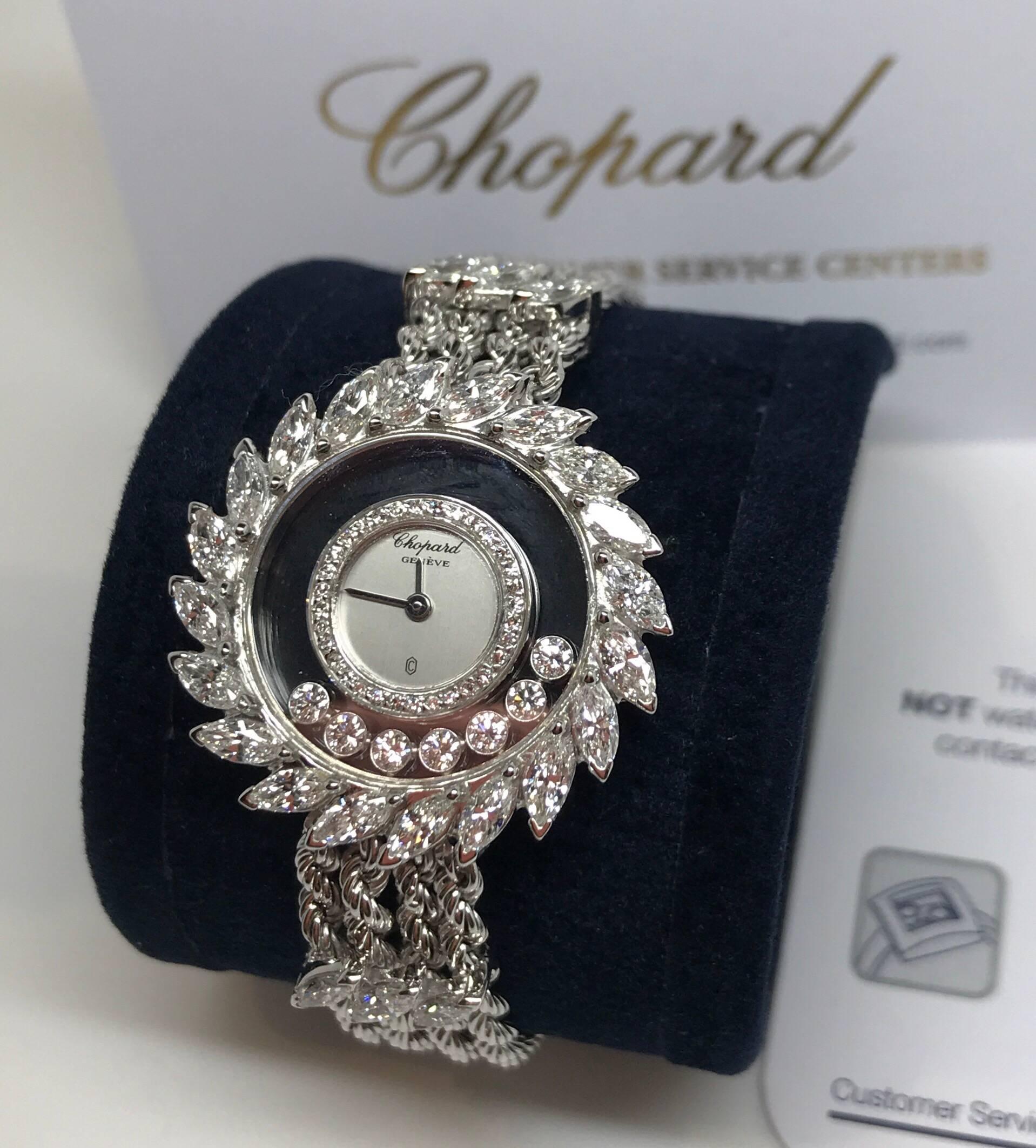 A Chopard Happy Diamonds Ladies luxury watch set in 18k white gold. The watch features a silvered dial with 32 diamond-set inner bezel of approx 1 carat and set within two scratch-resistant sapphire crystal plates containing seven white gold-mounted