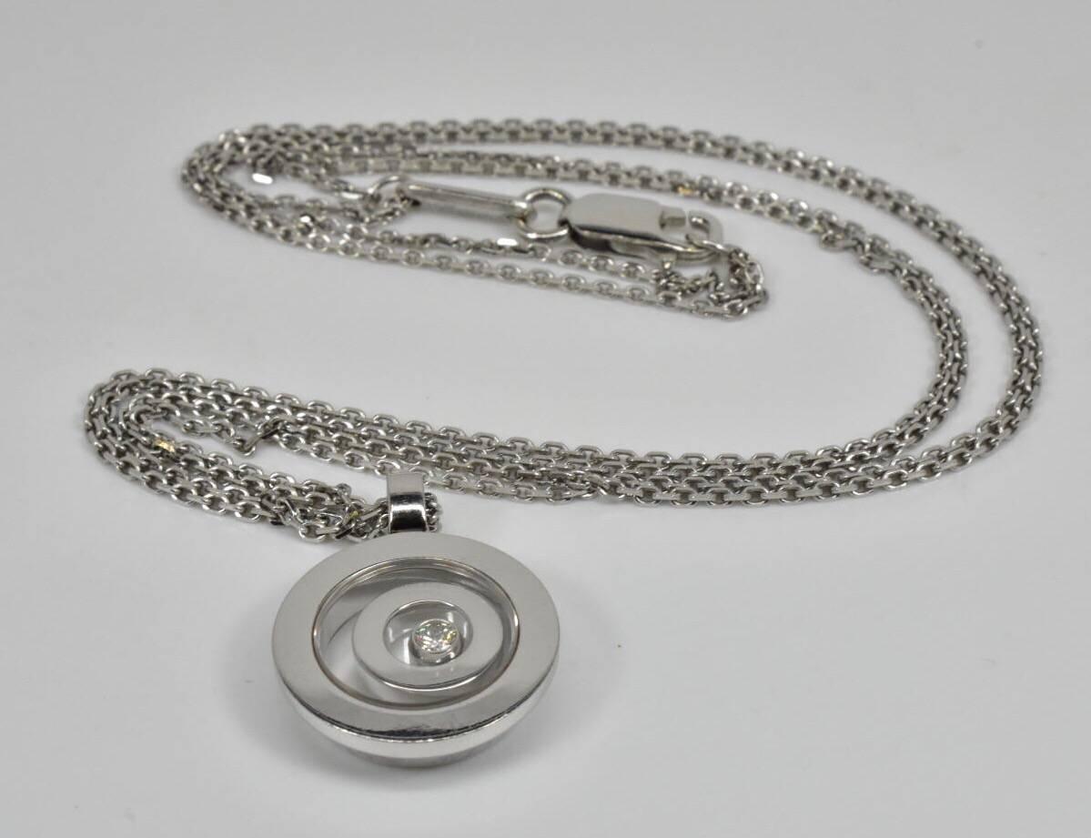 A Chopard 'Happy Spirit" diamond pendant necklace set in 18k white gold. The necklace features a round pendant with one free moving daimond under a sapphire glass with a frosted Chopard hallmark.
Current retail price £2,510
Lenght: 17.8