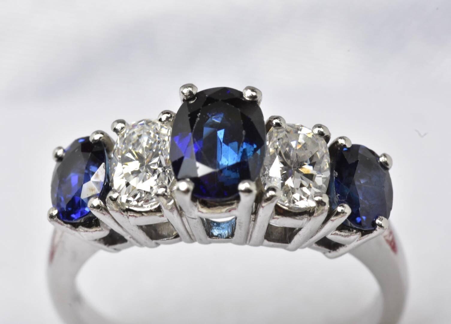 A five stone sapphire and diamond ring set in platinum. The ring feature three oval cut sapphire and two oval cut diamond to a plain platinum band.
Size J 1/2 US 5
Measurements: GEMSTONES: Diamonds - approx. 0.70 carats, Sapphires - 5mm x 3.6mm and