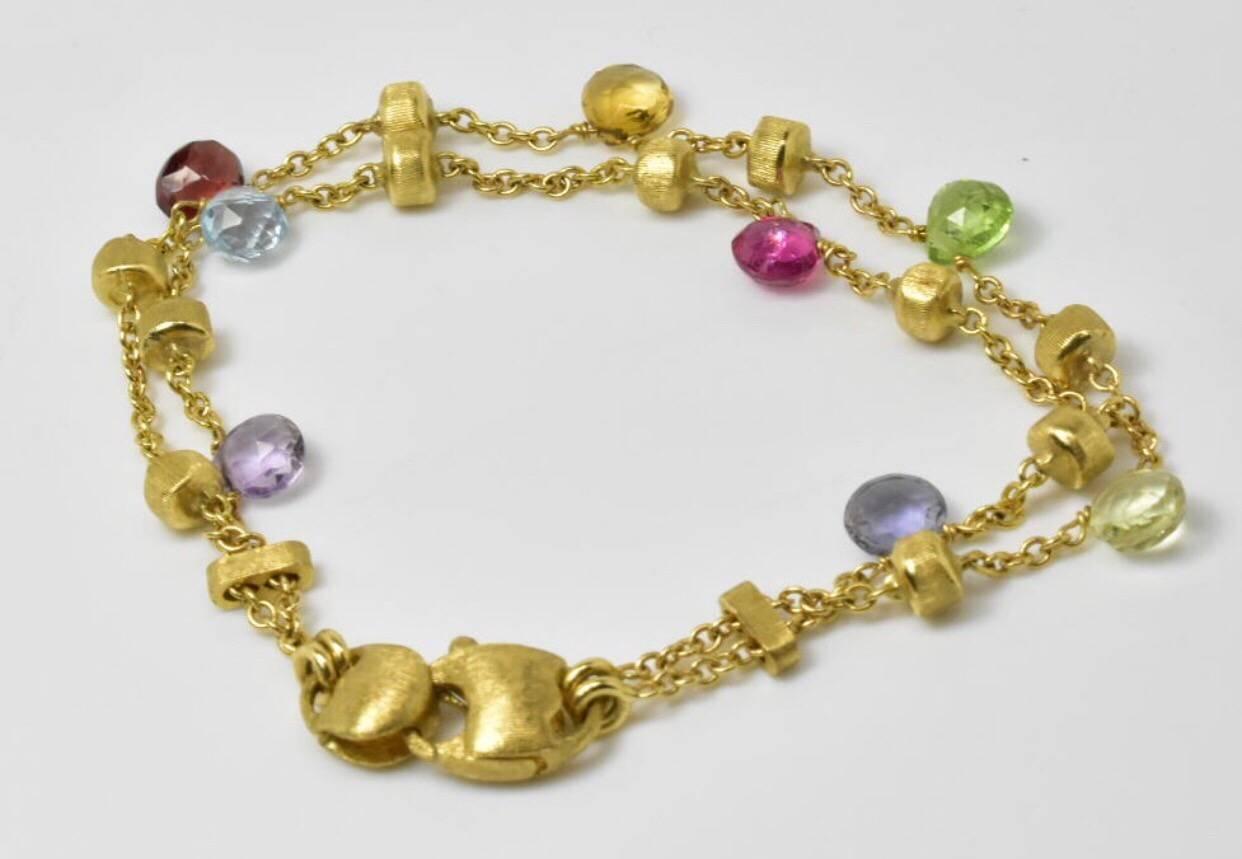A Marco Bicego paradise gem bracelet set in 18k yellow gold. Gemstones: Semi precious multi color gemstones.
Length: 6.3/8 long
Hallmarked: Marco Bicego, 750, Italian mark gold marks 
Weight: 9.4 grams.
Condition - Good condition with very little