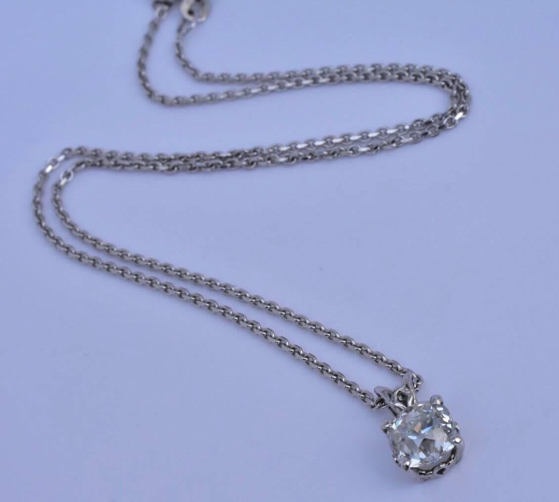 An old cut diamond pendant necklace set in 18k white gold. The necklace features a bright-white, sparkly European old cut diamond weighing approx 2 carats. The necklace is hallmarked 750 with standard gold markings. 
The necklace is not sold with a