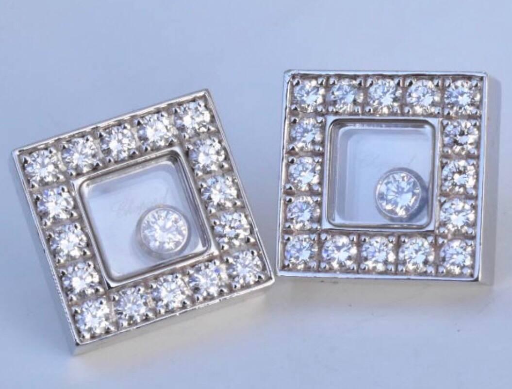 Chopard Happy Diamonds earring set in18k white gold. The border of the earrings are square and set with a total of 32 round cut white diamonds with a free moving a free moving single floating diamonds (0.11 carats for two floating diamonds) under a