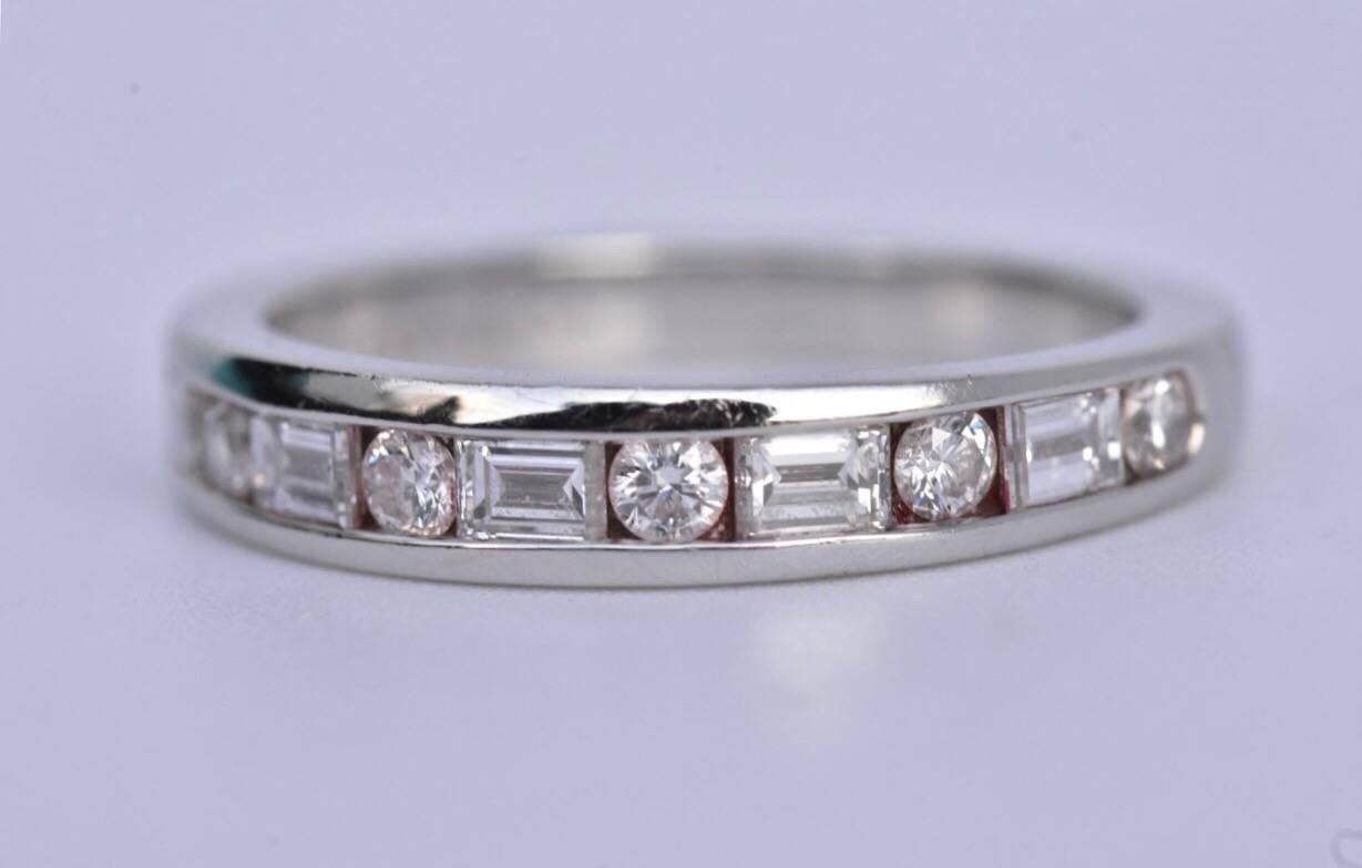 TIFFANY & Co Platinum Diamond Eternity Ring. The ring features five baguette-cut diamonds and six brilliant-cut Diamonds set to a plain platinum band. 
The ring is sold with original receipt of purchase from December 2012 ring box and outer box