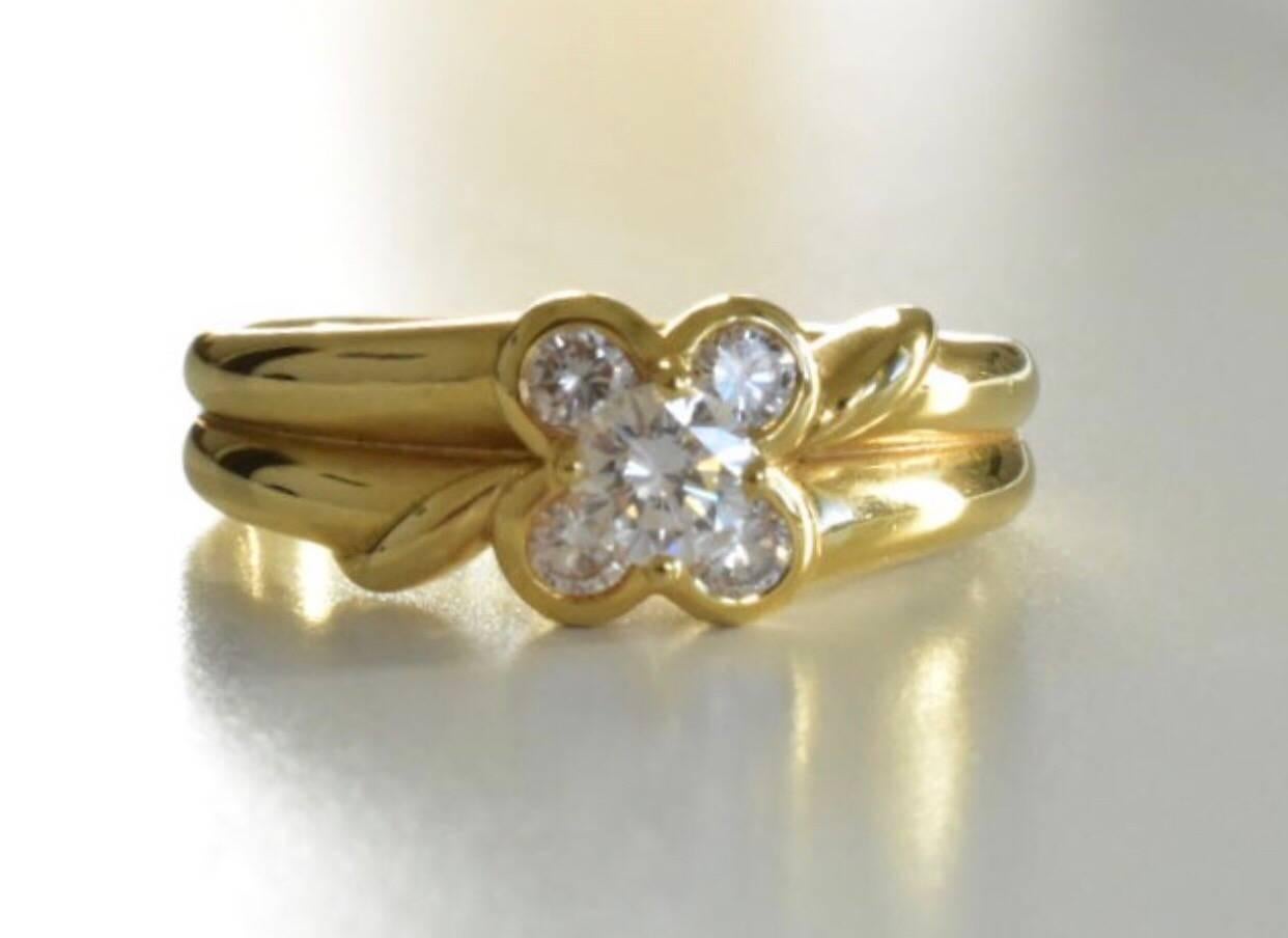 A vintage Van Cleefs Arpels Diamond ring set in18k yellow gold. The ring features flower design with a central brilliant-cut diamond of approx 0.20 carat, and additional four diamonds total 0.20 carat

Measurements: Ring top is 7.2m wide

Ring size