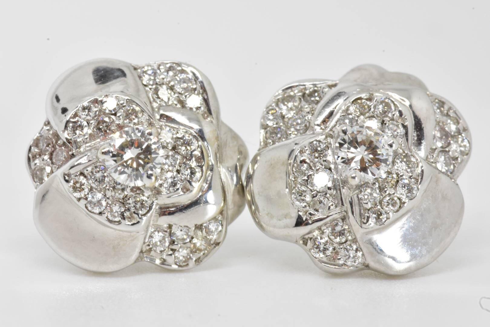 A pair of Chanel Camellia diamond stud earrings set in 18k white gold. Each earring features a central brilliant cut diamond of approx 0.10 carat with an additional 29 small brilliant cut diamond set to a camellia flower shape setting.
Measurements: